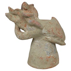 Antique Greek figurine of a little Eros riding on a dolphin, holding a lyre