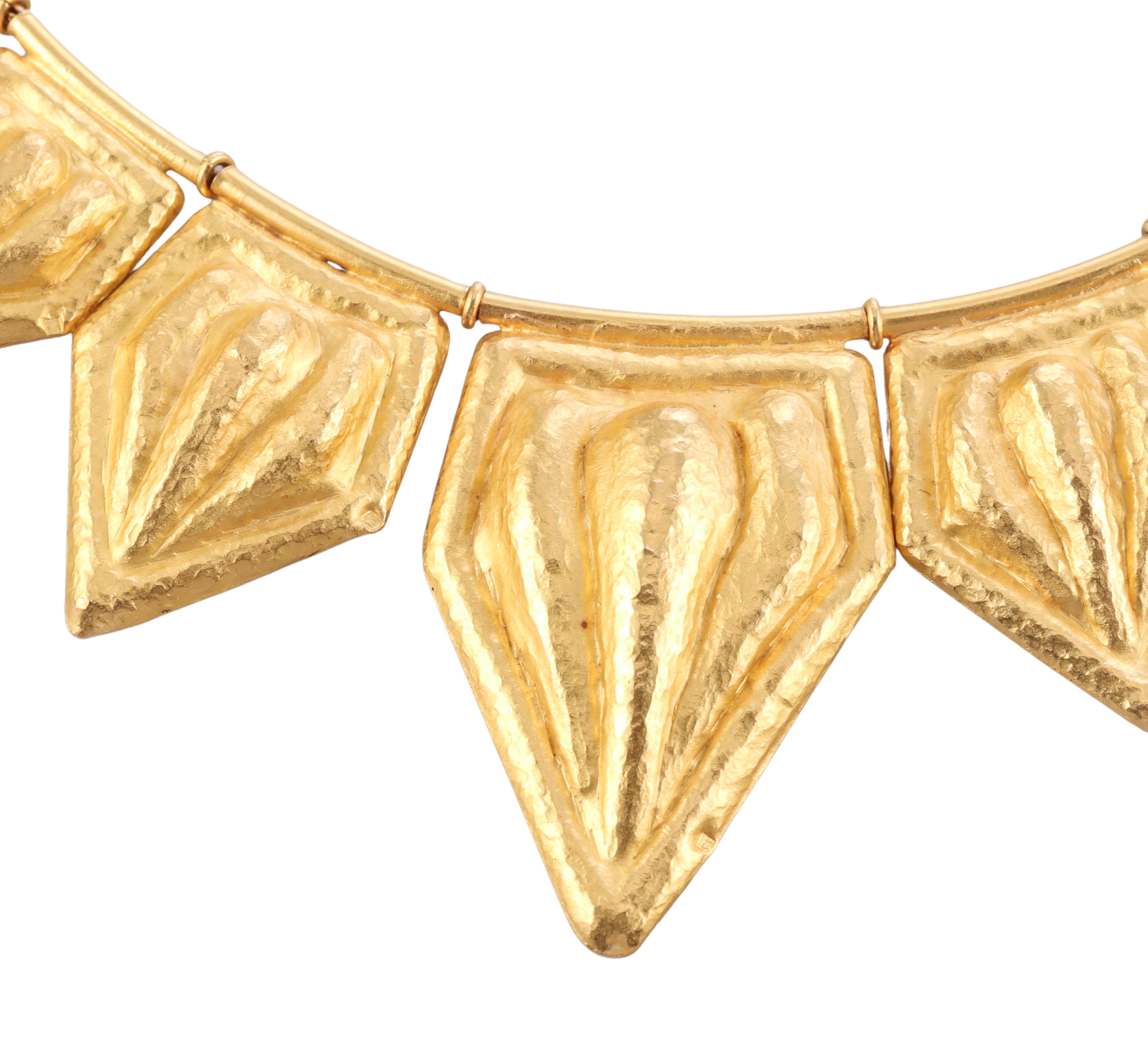 Greek made in 18k hand hammered gold, this necklace features 17 plaque movable elements. The necklace is 14