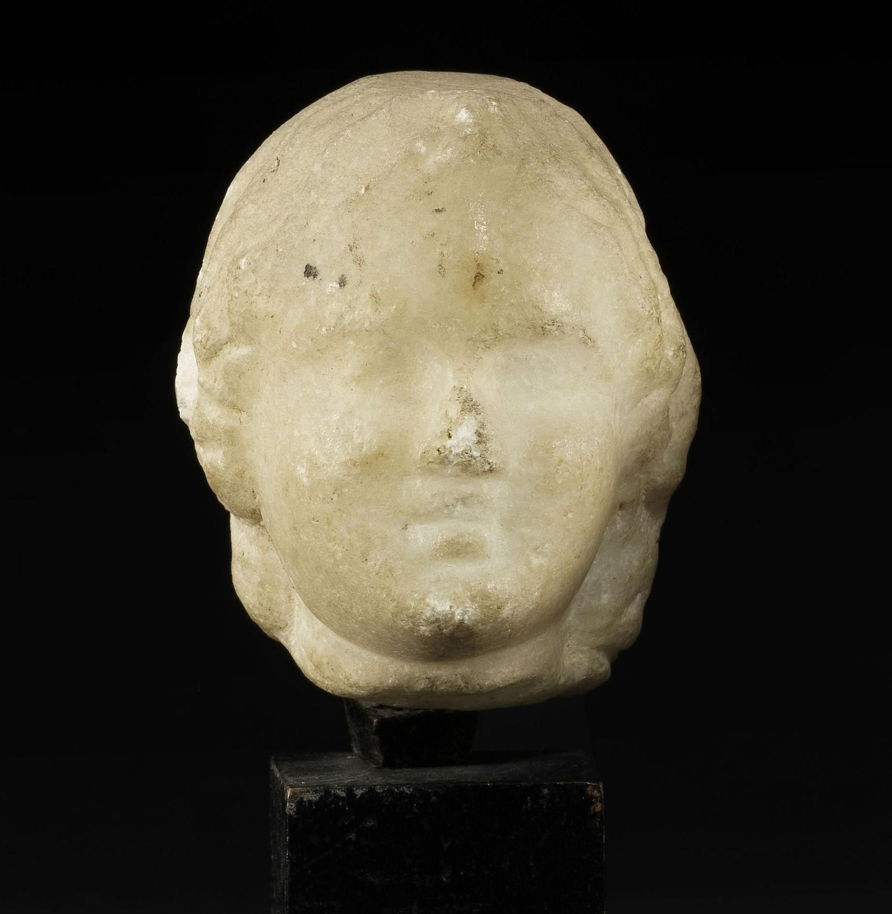 ITEM: Head
MATERIAL: Marble
CULTURE: Greek, Hellenistic period
PERIOD: 3rd – 1st Century B.C
DIMENSIONS: 55 mm x 47 mm x 47 mm
CONDITION: Good condition. Includes stand
PROVENANCE: Ex Swiss private collection, acquired since at least 1982

Comes