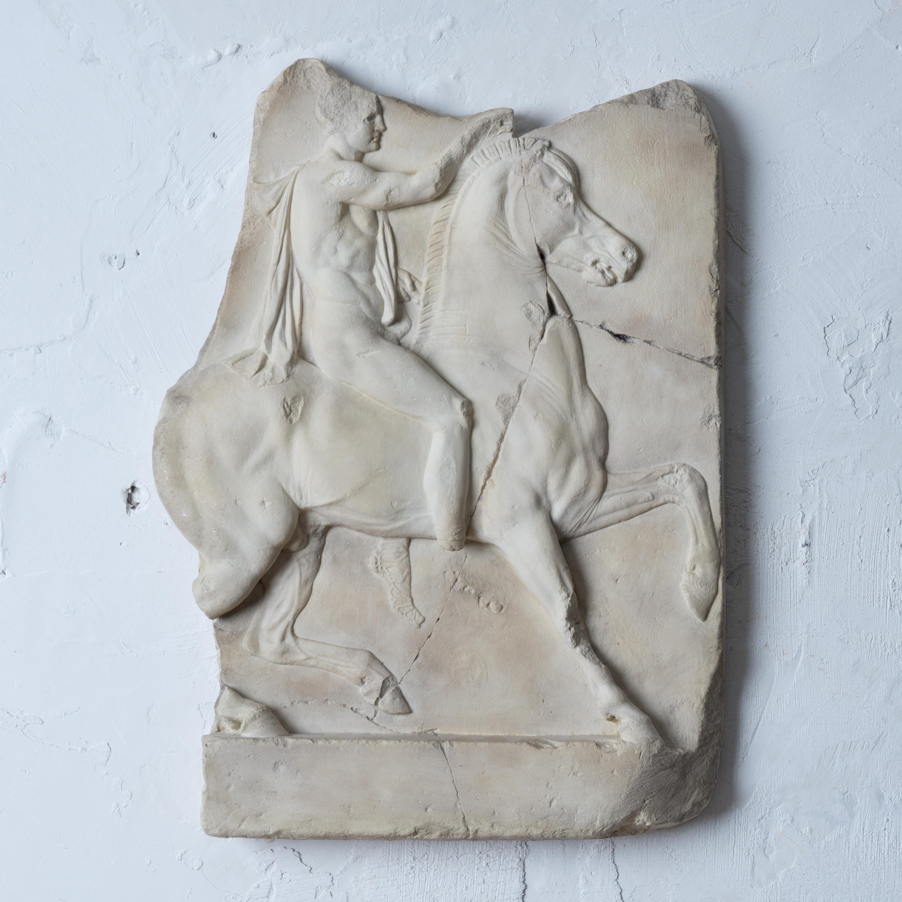 A museum copy of a first century B.C. Greek marble relief of a horseman.
Cast in composition stone for Met Museum, mid-20th century.

13 inches wide by 17 ½ inches tall by 2 inches deep 

