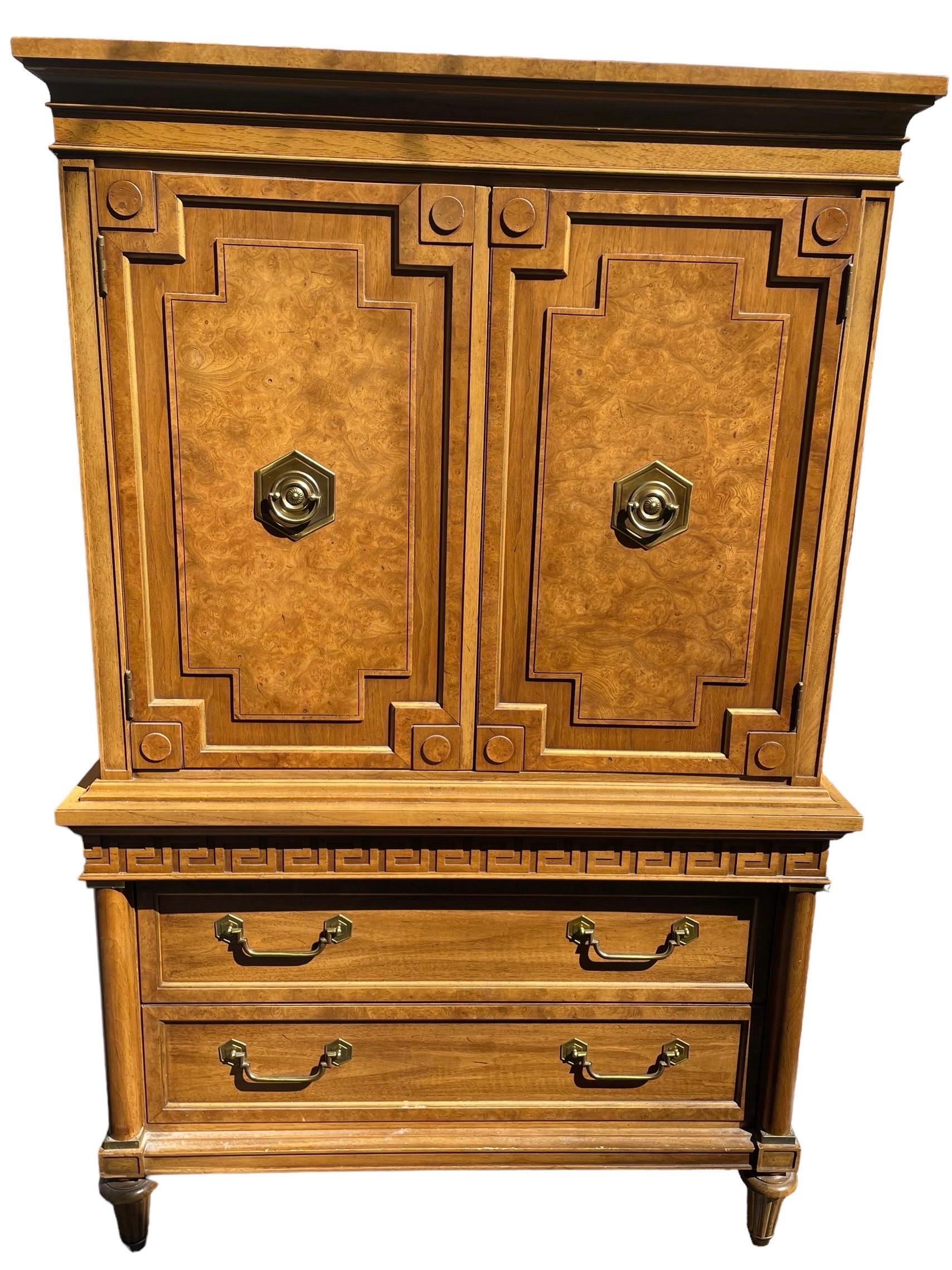 This glamorous vintage Greek Key Highboy by Thomasville is made of solid wood. 

The exterior has the signature Greek key trim and beautiful pulls in solid brass. Above is plenty of space for storage. 3 Shelves and cubbys inside. Below 2 drawers.
