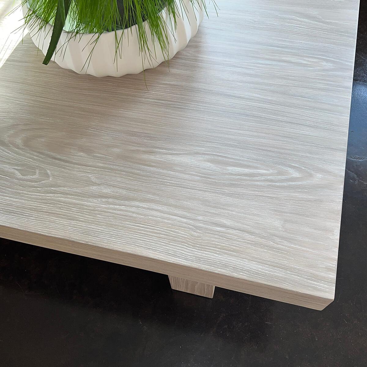 The sleek lines and whitewash ash veneer exude a sense of serenity and tranquility, while the Greek key details add a touch of classical architecture to the mix. This table is the perfect blend of simplicity and sophistication, making it a versatile