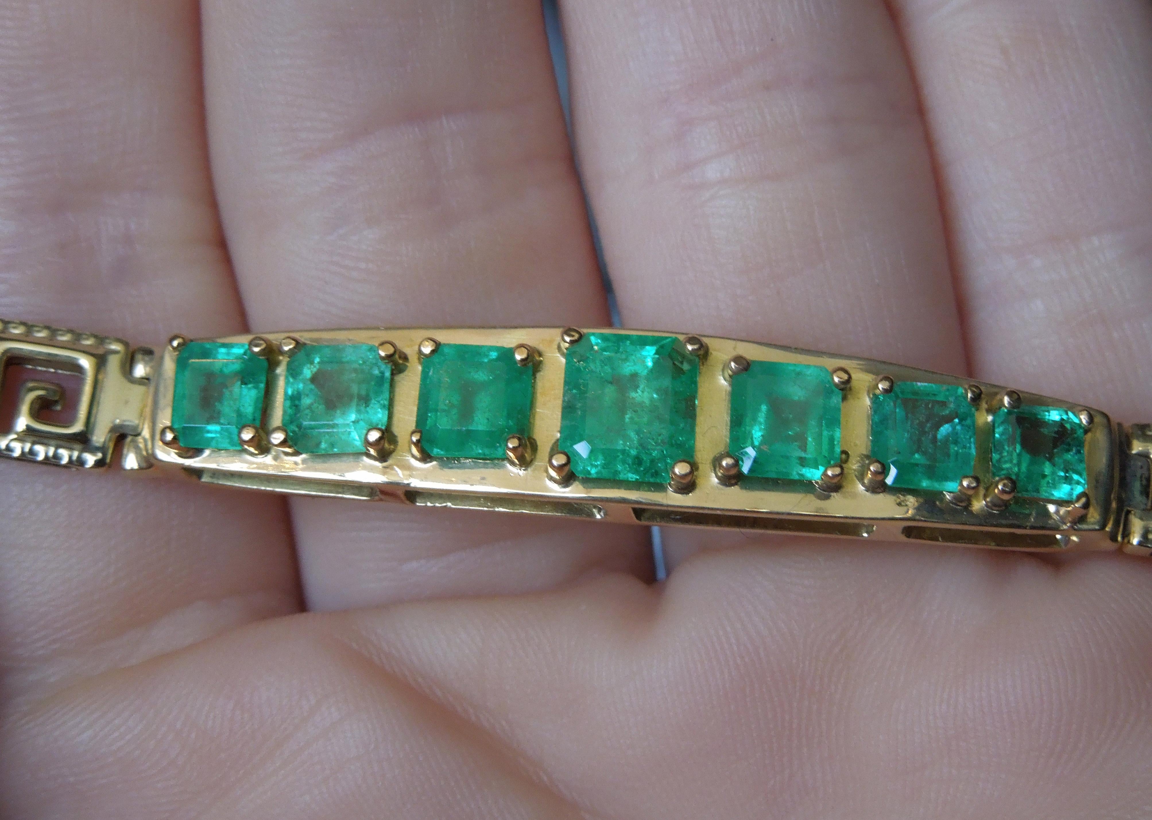 In a Unisex design, this 14 Karat Yellow Gold Greek Key Emerald Bracelet features 7 Graduating Square Emerald cut Natural Colombian Emeralds totaling approximately 7 carats, each secured in a 4-Prong setting .. [nearly the same shade of Jacqueline