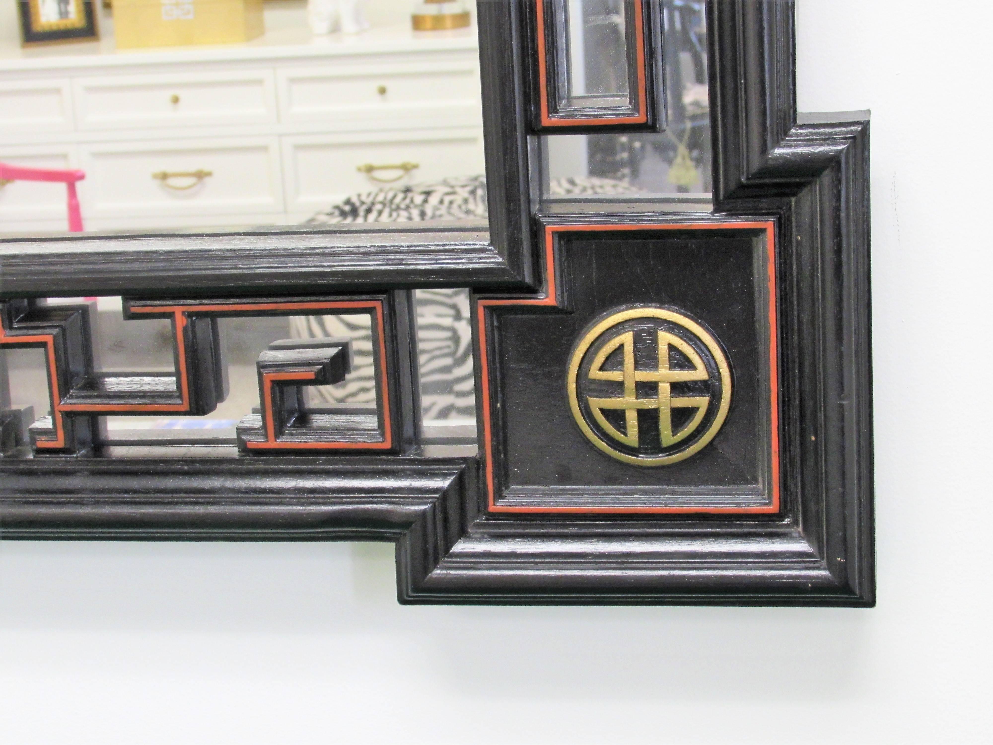 Large Greek key ebonized mirror, each corner is gilded chinoiserie design with red outlines on all sides, can be hung vertical or horizontal.