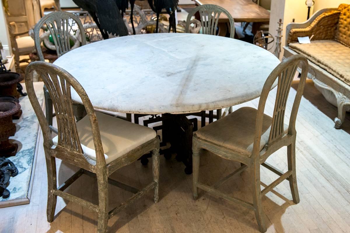 A Greek key decorative base table with an aged Carrara marble top. Patina is everything on this table!
 