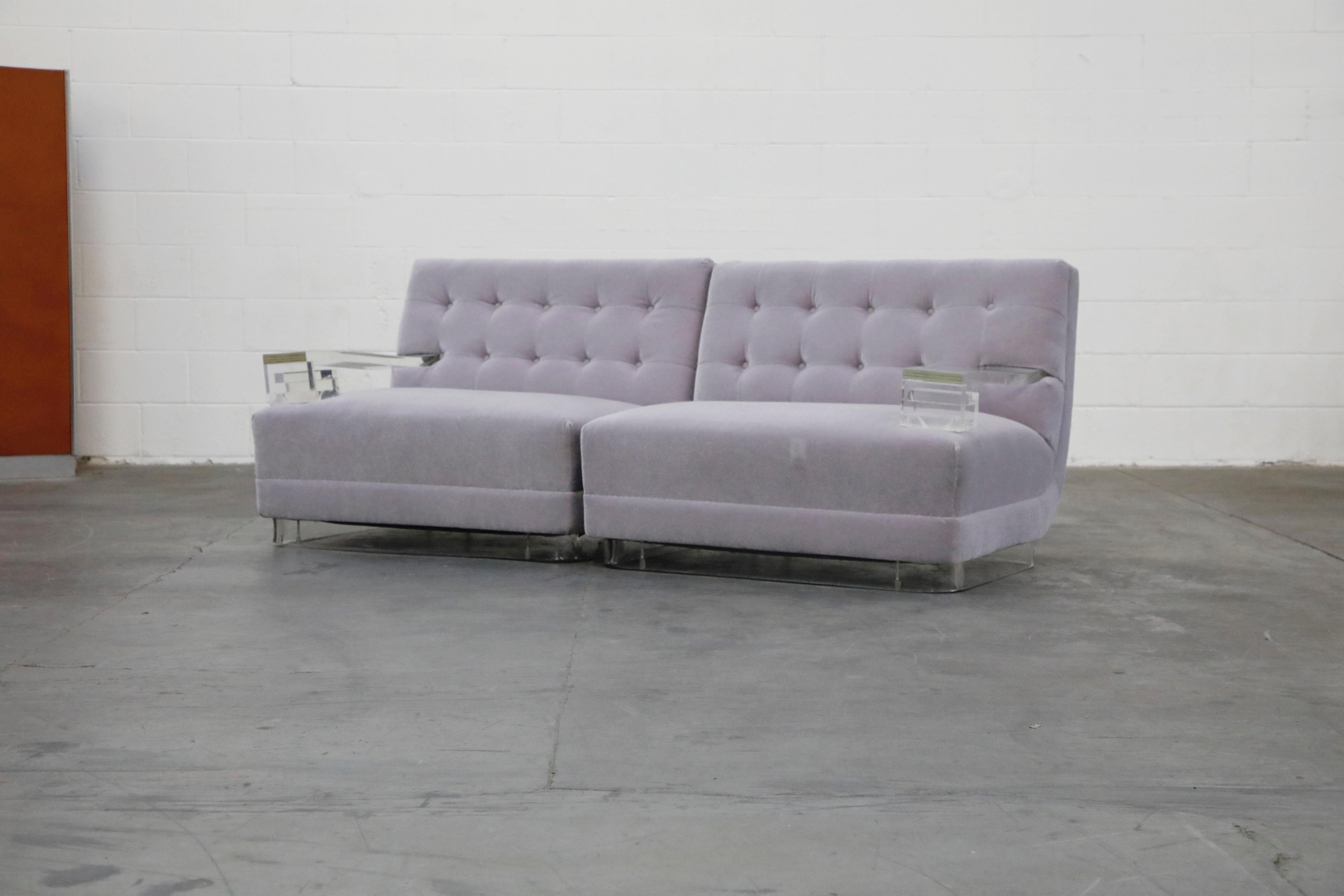 An amazing pair of reupholstered mohair 1960s club chairs, that when placed together create a loveseat, with Lucite Greek Key arms and base along with recently reupholstered lavender mohair. This Hollywood Regency pair of single-arm lounge chairs