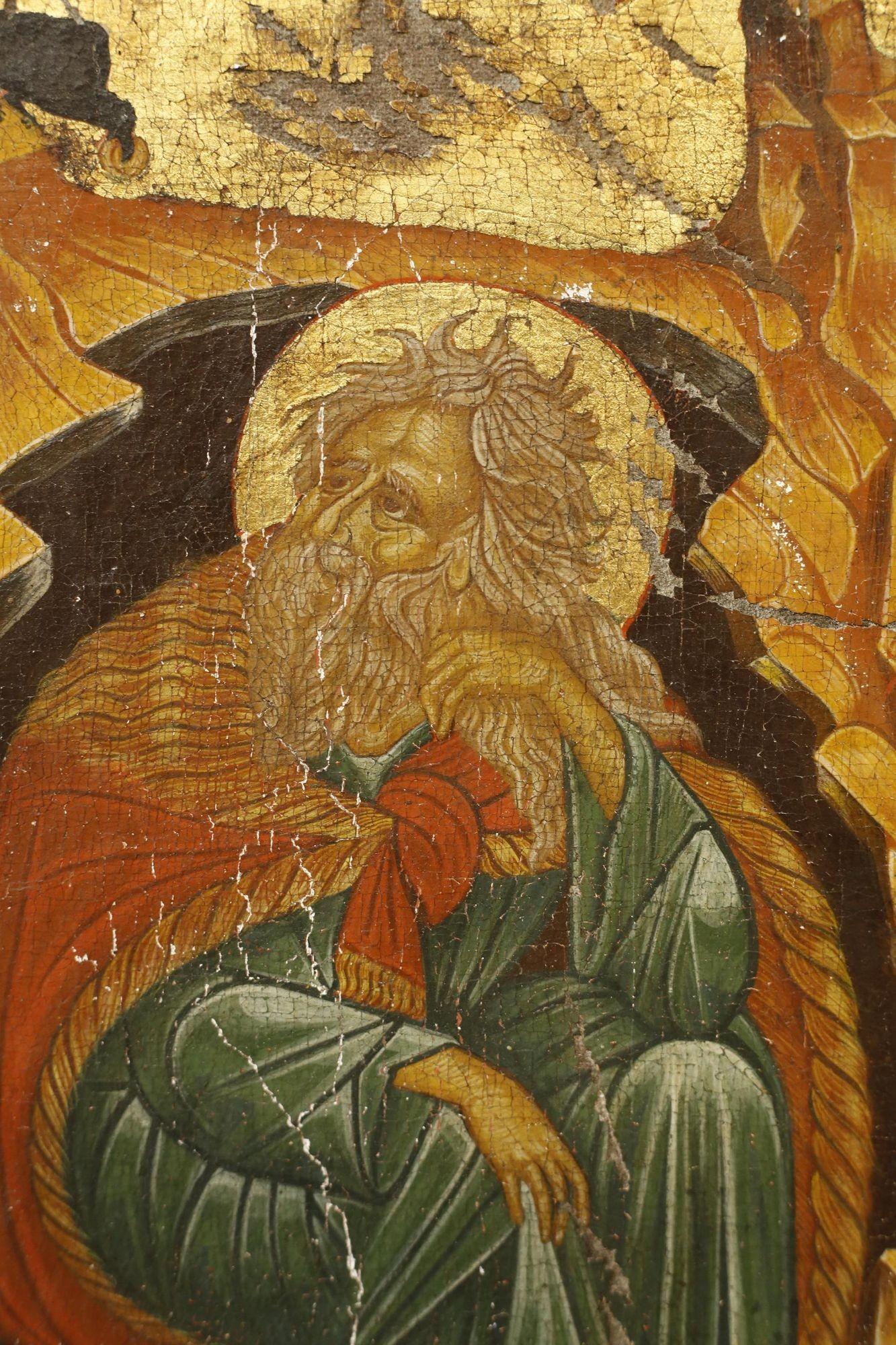 This is a very nicely painted Greek orthodox icon depicting a man on the floor in green gown. It is well worn and has a very attractive appearance. Great quality to the work and the gnarled chunk of wood it is on is wonderful. Age is hard to judge