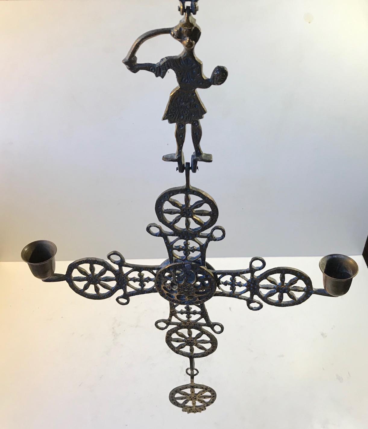 Byzantine inspired hanging pendant cross in ornate textured bronze. Greek Orthodox in style. Measuring 70 cm in length it can be hung from the ceiling or on the wall. It was made in Greece circa 1920 and probably by a metalshop called Smaltotex. It