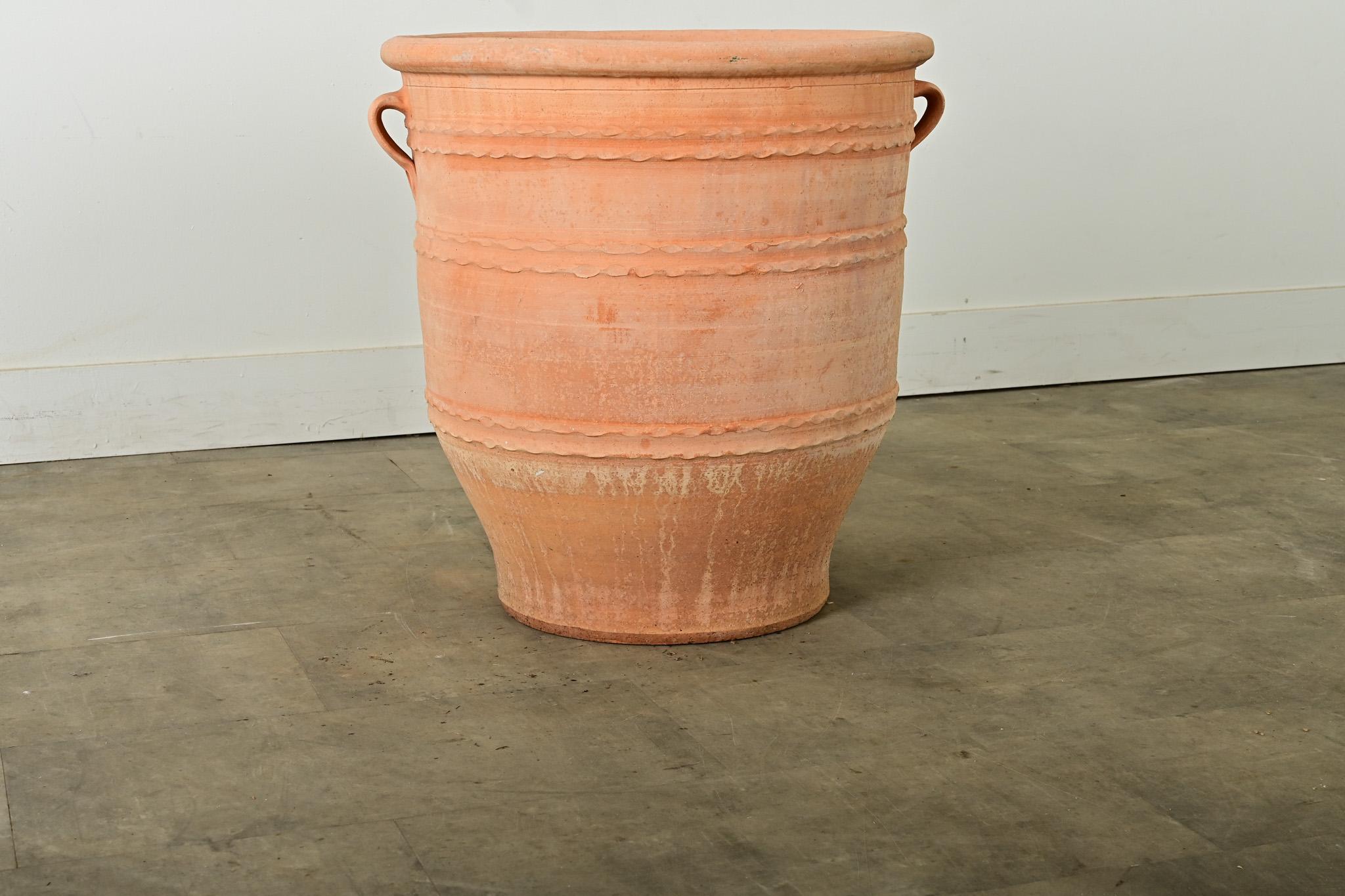 Greek reproduction terracotta pot, or planter, made on the island of Crete using centuries if not millennia-old techniques to achieve their specialized forms decorated with a ringed motif of twisting ribbons. Based on ancient Minoan storage pottery