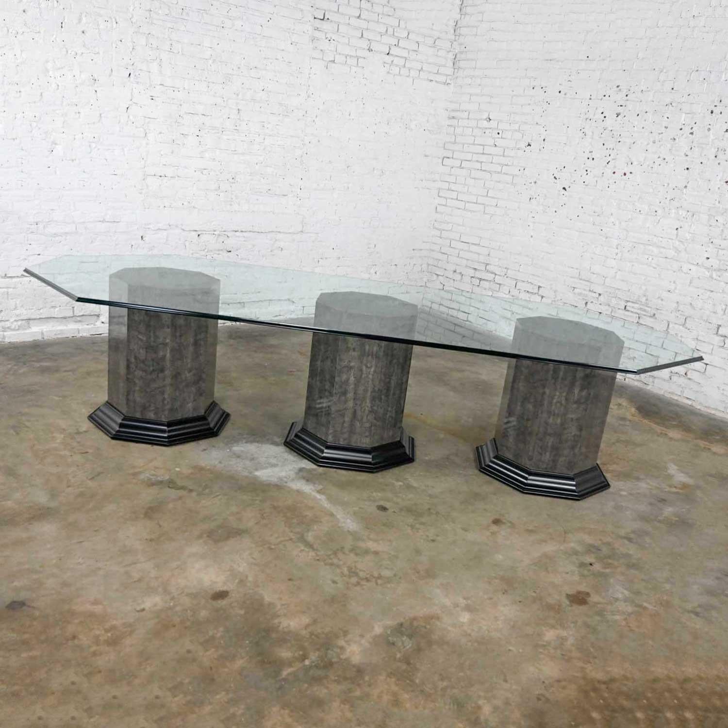 Wonderful Greek Revival large dining table with a gray & black marbleized technique laminate covered triple octagon pedestal base & an elongated octagon glass top with beveled edges Attributed to Bernhardt. Beautiful condition, keeping in mind that