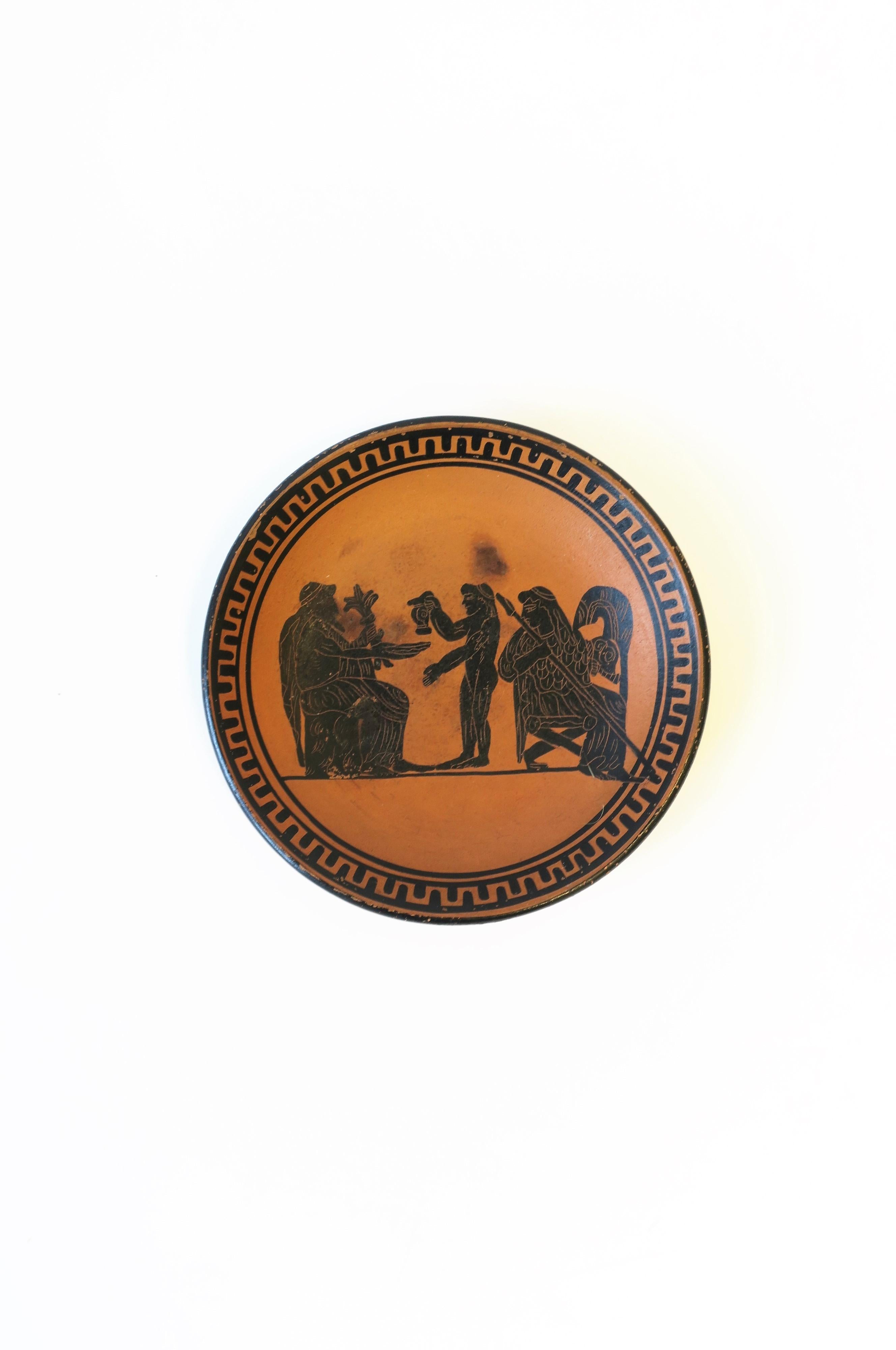 A handmade Greek Revival relief terracotta matte pottery plate from Greece, circa mid-late 20th century, Greece. Piece is marked 