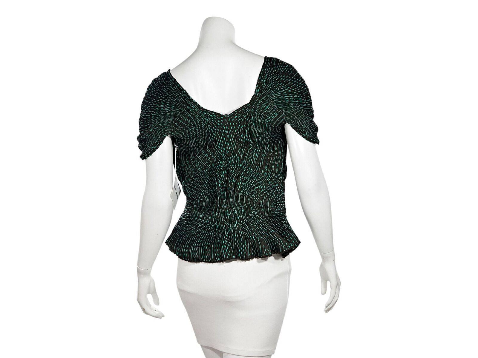 green pleated blouse