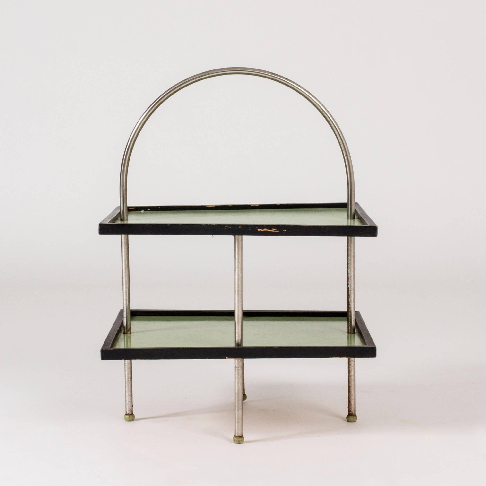 Neat Swedish functionalist side table with light graphic lines, made from metal and green and black lacquered wood. Easy to pick up and move around.