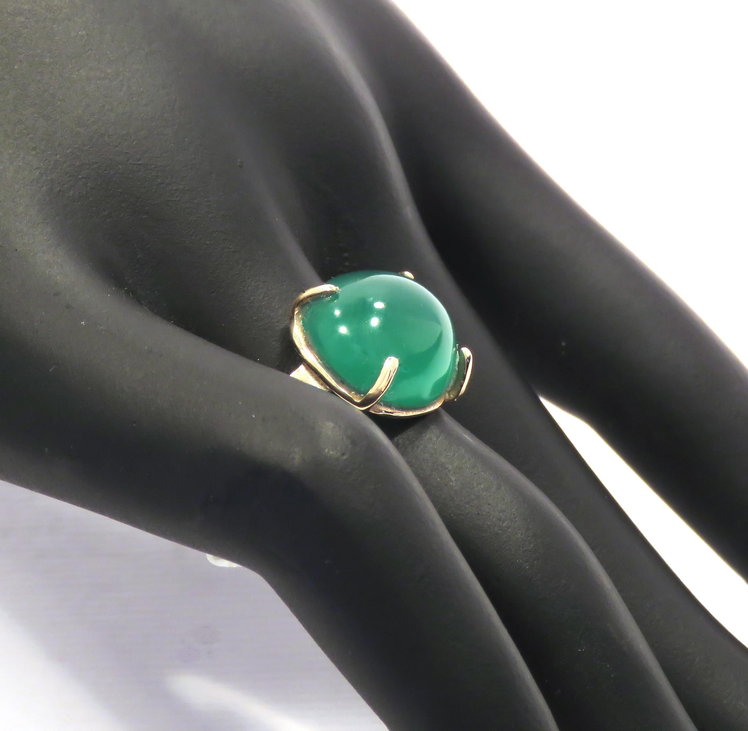 Beautiful green agate featured in a contemporary ring crafted in 9 karat rose gold. The green agate is cabochon cut  and oval shaped and is held by 4 claws, the stem is finished in hammered gold, this is completely done by hand. The size of the