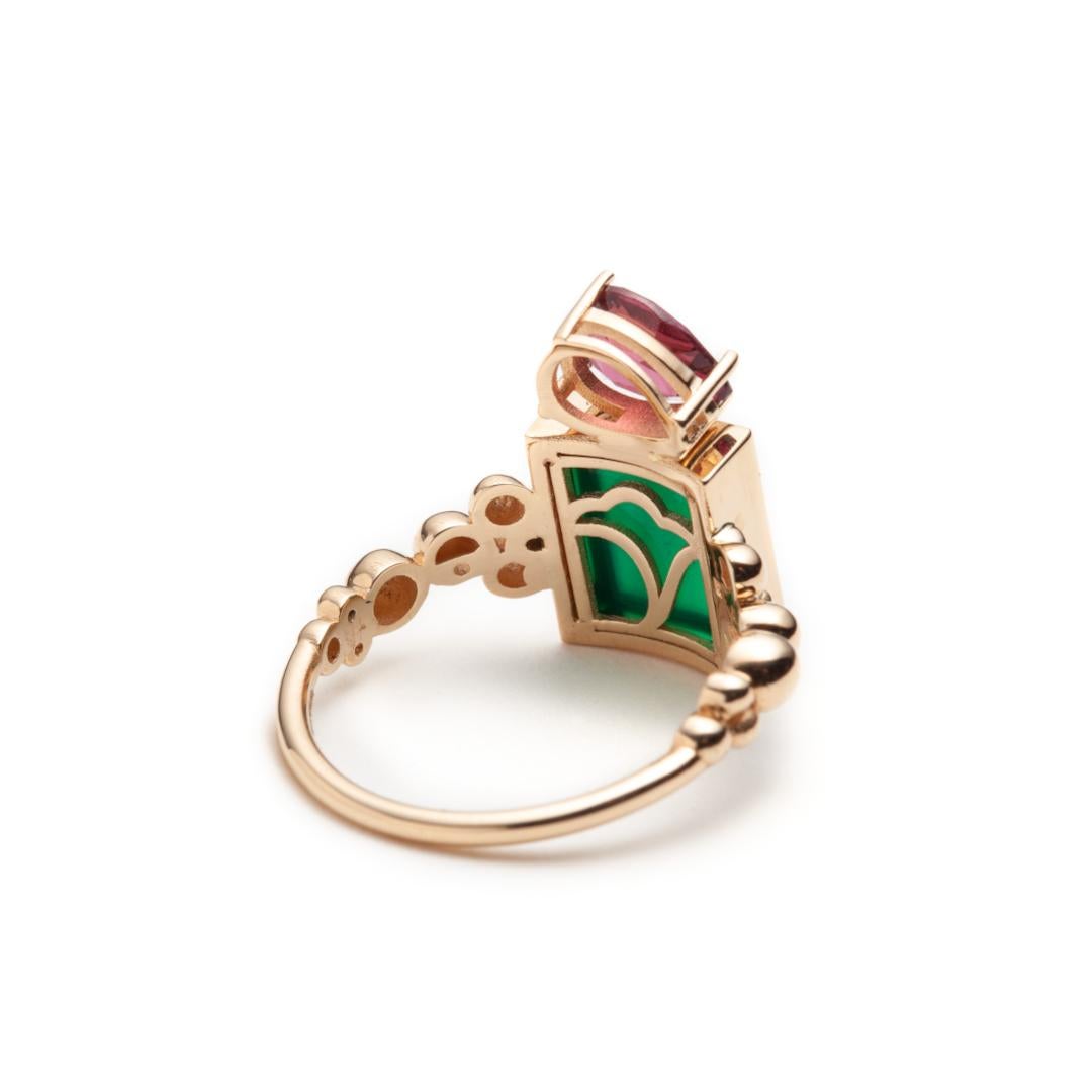 We make this colorful ring in 14k yellow gold set with a rectangular green agate plate and a rhodolite garnet teardrop. The top measurements, covering both stones are 16 mm x 9 mm x 4.5 mm. When the light hits the ring at a certain angle, our