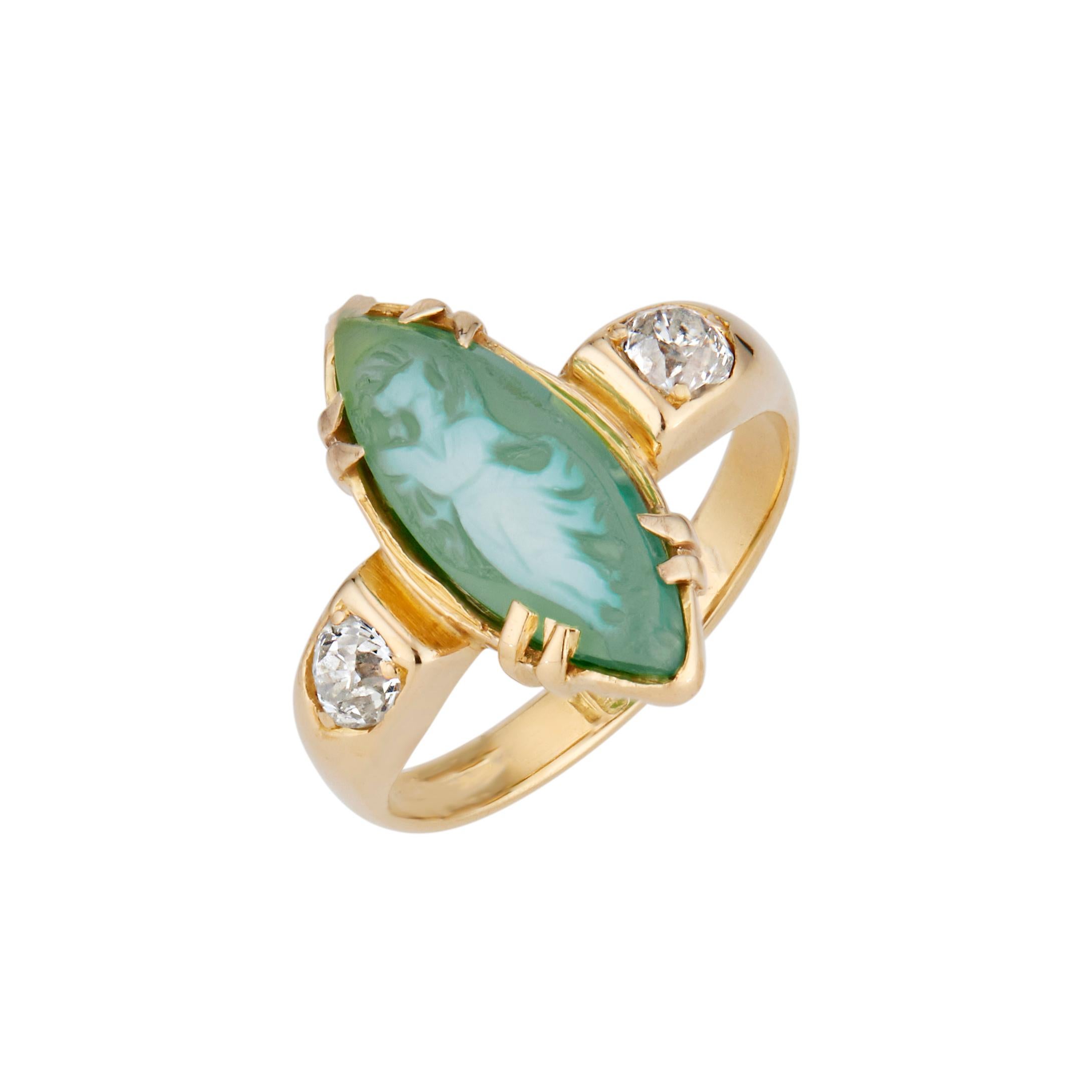 Estate 1920's green agate and diamond ring. Green female form cameo marquise agate center stone with 2 old European cut side diamonds in a 18k yellow gold setting. 

1 marquise shape greenish white agate cameo, 15mm x 5.8mm
2 Old European cut