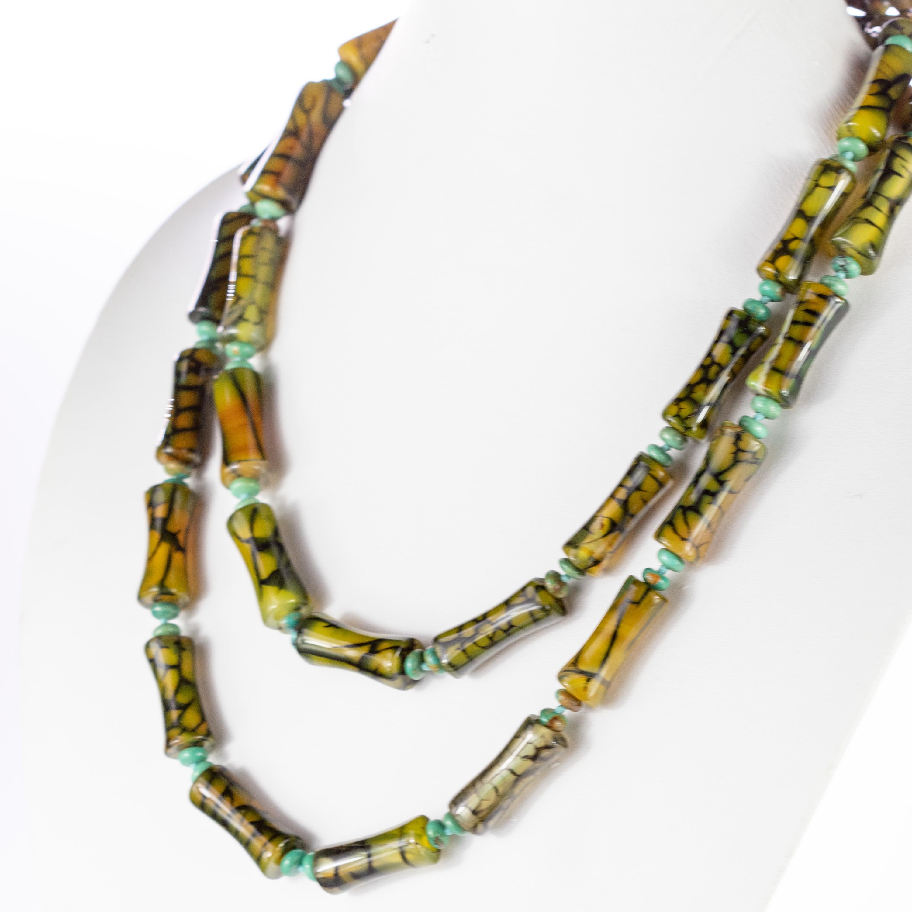 info?
Long wrap around necklace with variegated green agate tubes and round natural turquoise. Breathtaking and one of a kind handmade embellished with extraordinary colors evoking a volcano. Oranges, brown and greens with multiple hues come