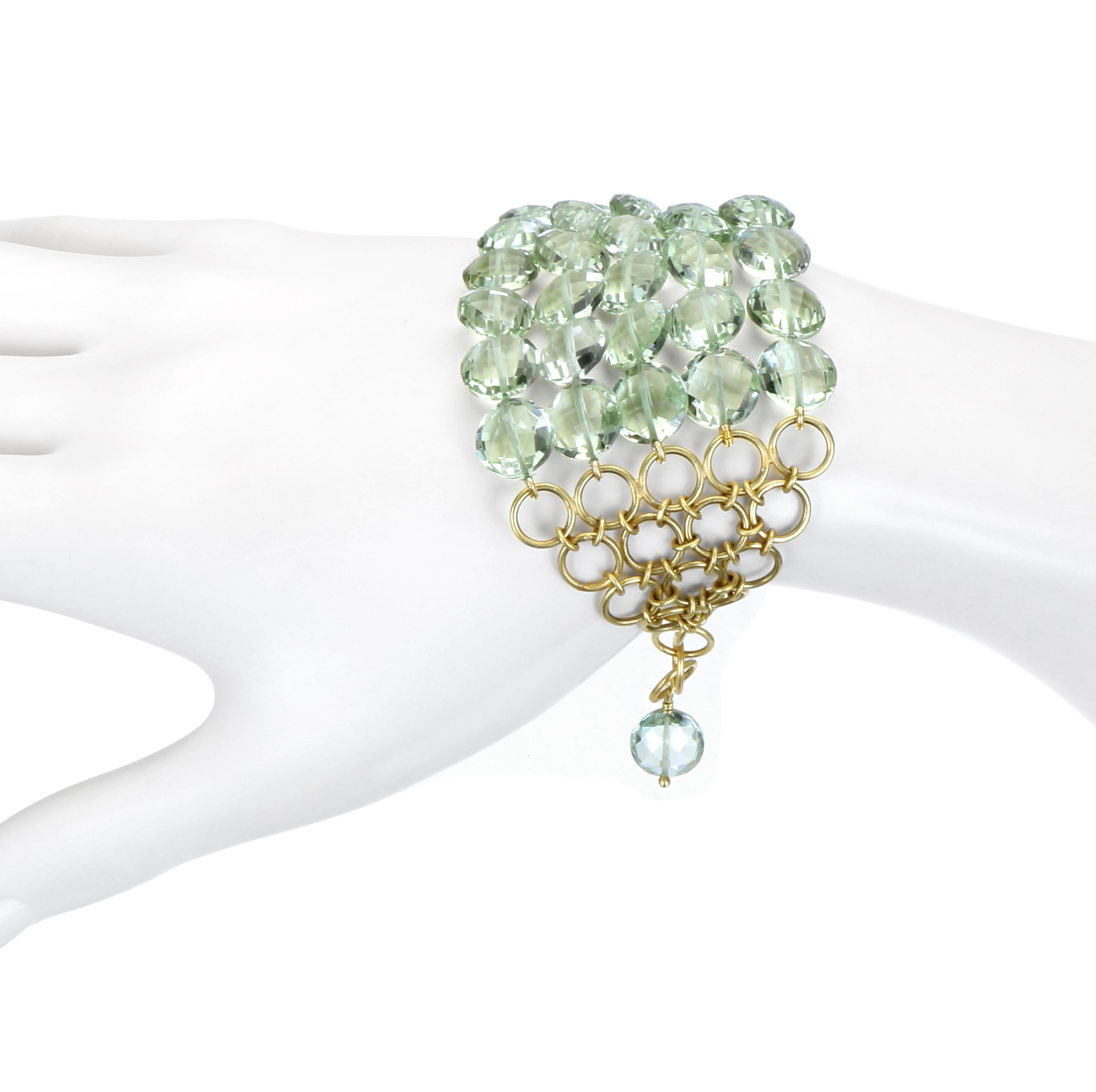 The look of a chunky cuff with the flexibility of a chain bracelet gives this piece it's uniqueness in style and texture.  Green amethyst disc beads and 18k green* gold links are perfect together in creating a statement bracelet for the modern