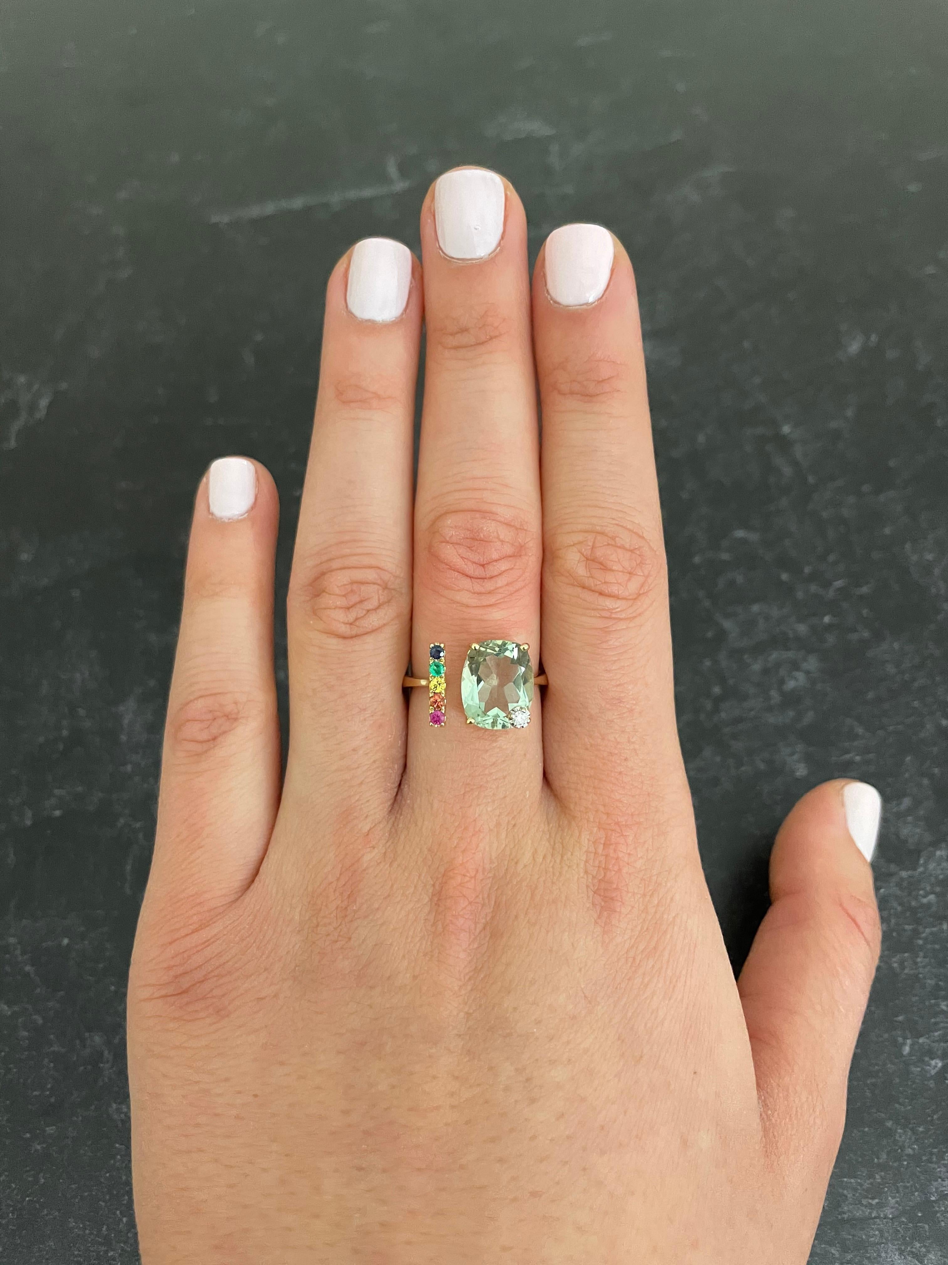 Material: 14k Yellow Gold 
Center Stone Details: 1 Cushion Cut Green Amethyst at 3.50 Carats - Measuring 11 x 9 mm 
Mounting Stone Details: 5 Multicolor Sapphires at 0.30 Carats
Diamond Details: 1 Brilliant Round White Diamond at Approximately 0.03