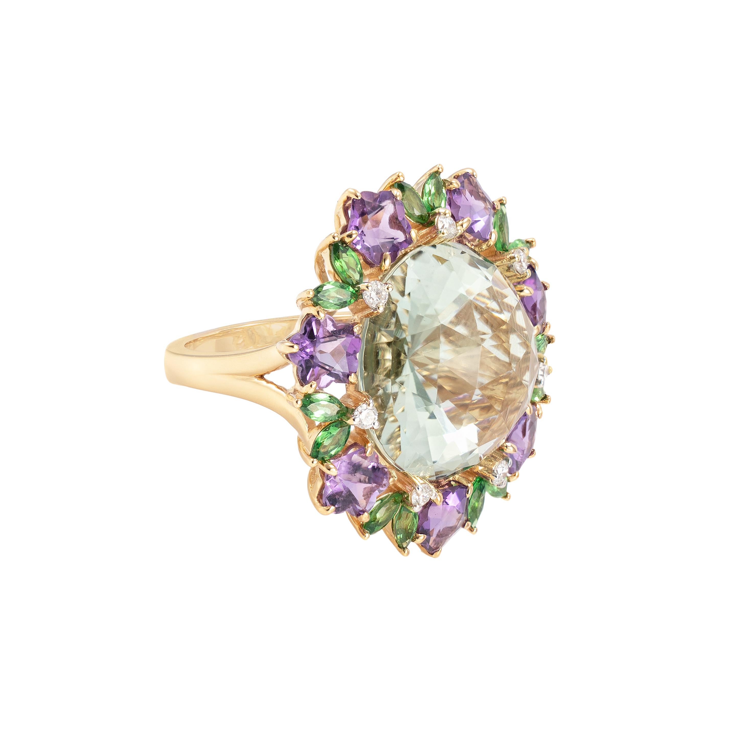 Sunita Nahata presents a collection of bold and colorful cocktail rings. This ring features a subtle yet eye-catching green amethyst at the center. The amethyst is accented with flower shaped amethysts, and marquise shaped tsavorites in a unique yet