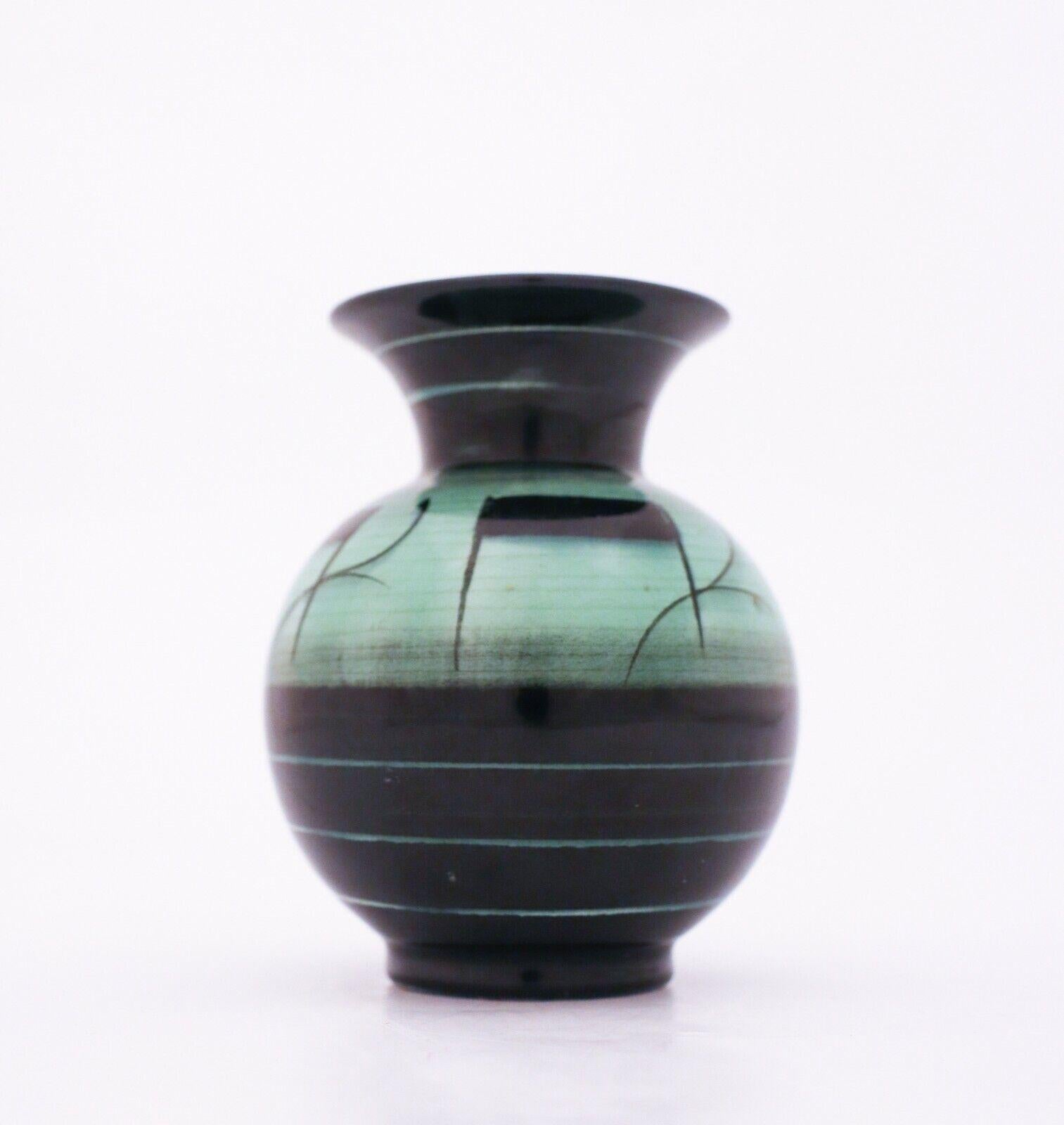 Art Deco at its best! A lovely green and black vase designed by Ilse Claesson in the 1930s at Rörstrand, Sweden. It is 11 cm high and in very good condition except from some craquelure in the glaze because of the age.