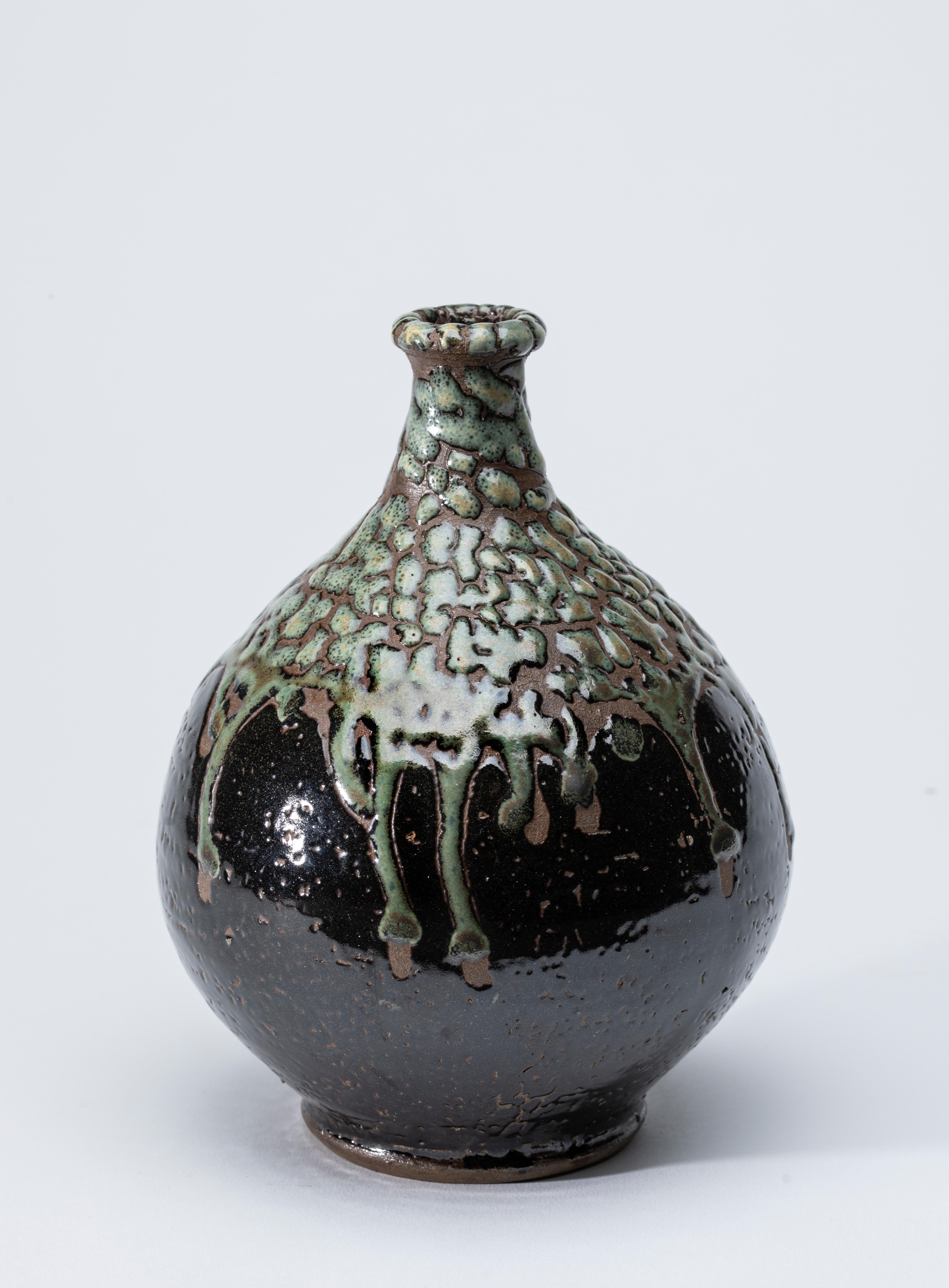 Green and Dark Brown Japanese Vase with Green Raised Glaze 

This vase is lovely from every angle.
We filmed all sides as well as top and bottom.
And, we were stunned by the beauty of this work of art.
The bottom half appears to be a very Dark