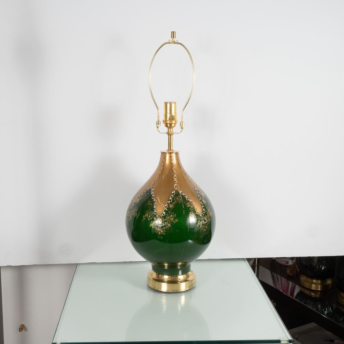 Single green and gold painted glass table lamp with hand painted filigree details.