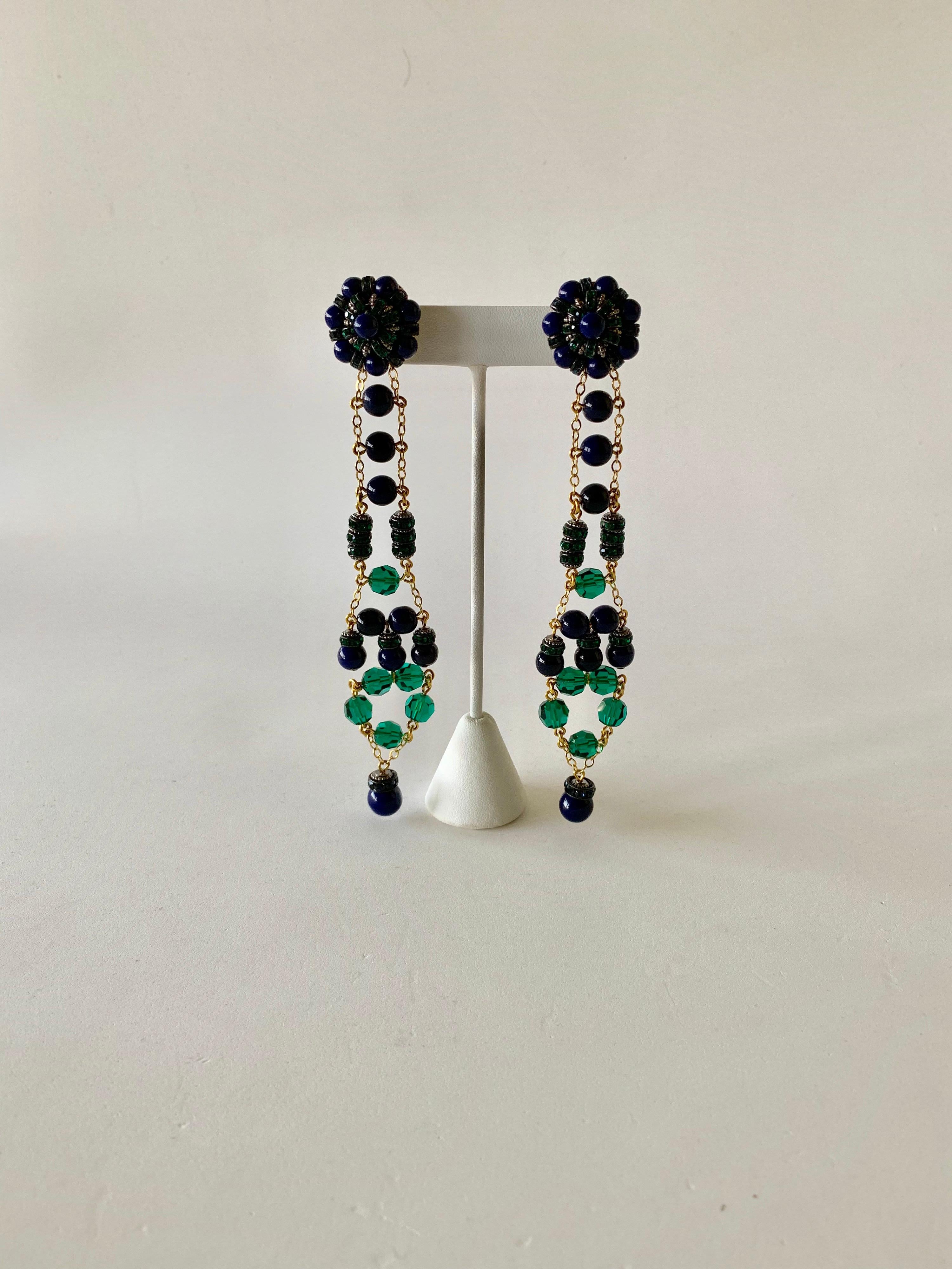 Green and navy blue contemporary French designer chandelier clip-on statement earrings created by Francoise Montague Paris, Circa 2000s. The long linear earrings are comprised out of gilt chain and a mixture of smooth blue glass beads which are