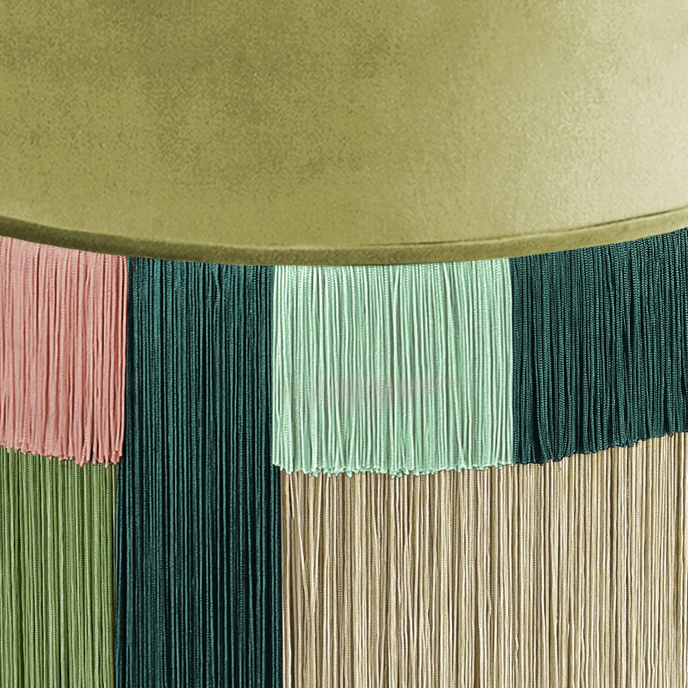 Mostly monochromatic, but with a touch of pink, this charming round pouf features viscose fringe cut to different lengths to create a unique geometric effect. In olive, emerald and sea foam green, the pouf is accented with a small square of pink,