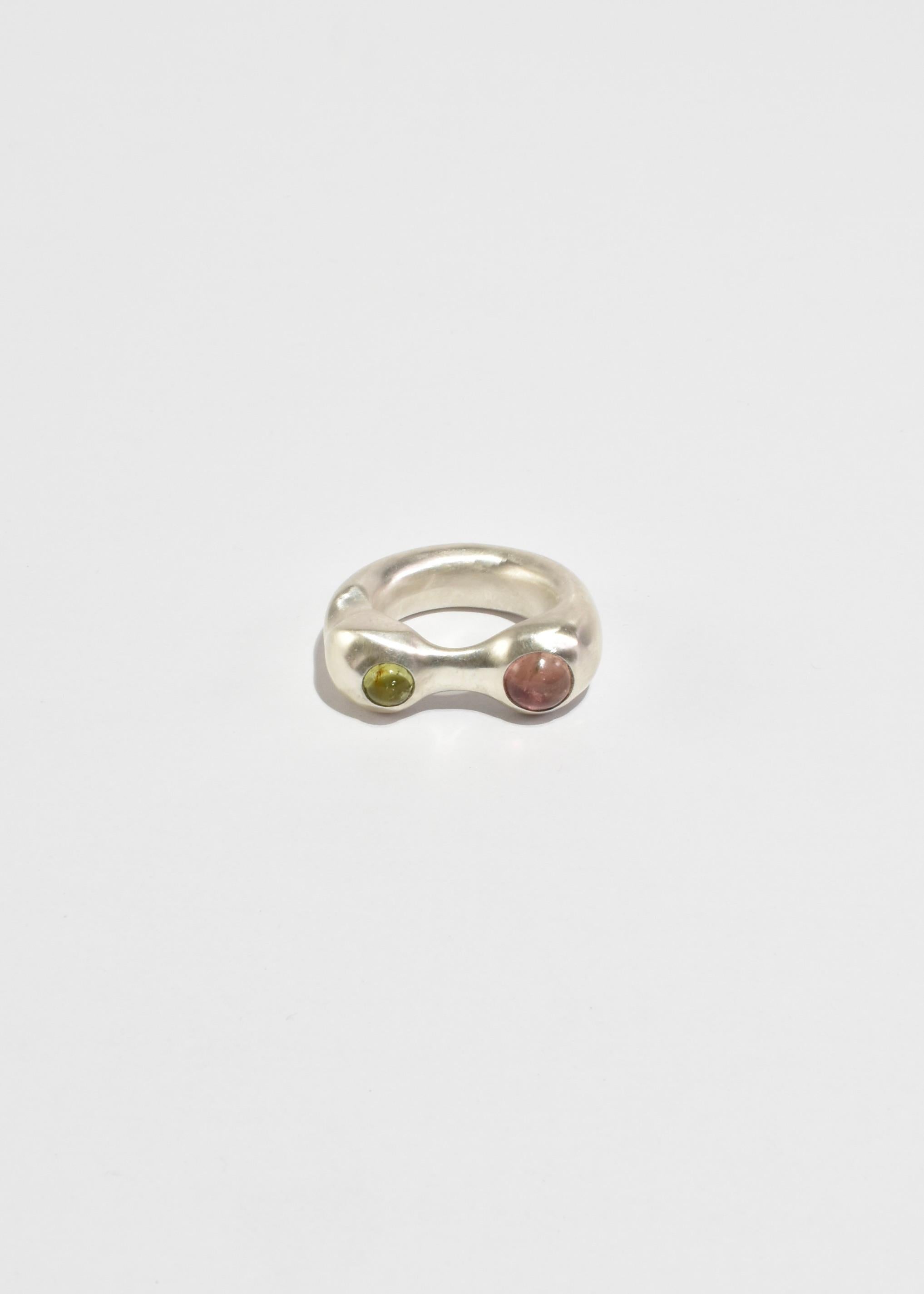 Sterling hand carved and cast organic shaped ring with two round tourmaline stones in pink and green.

Each piece is hand carved and finished in Virginia by Shauna Dunn of First Edition.

Material: Sterling silver, tourmaline.

We recommend storing