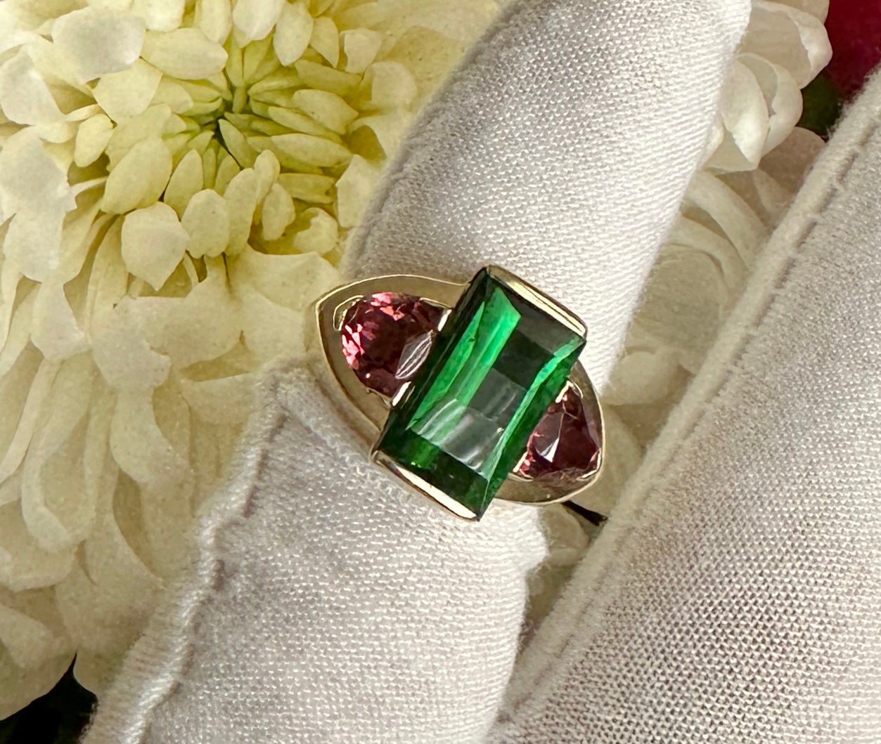 This is a magnificent original Green and Pink Tourmaline Ring in 10 Karat Yellow Gold.  The central Fine Green Tourmaline is emerald cut and is 14mm by 8mm. 
 It is a gorgeous large tourmaline of magnificent color and cut.  On either side are two