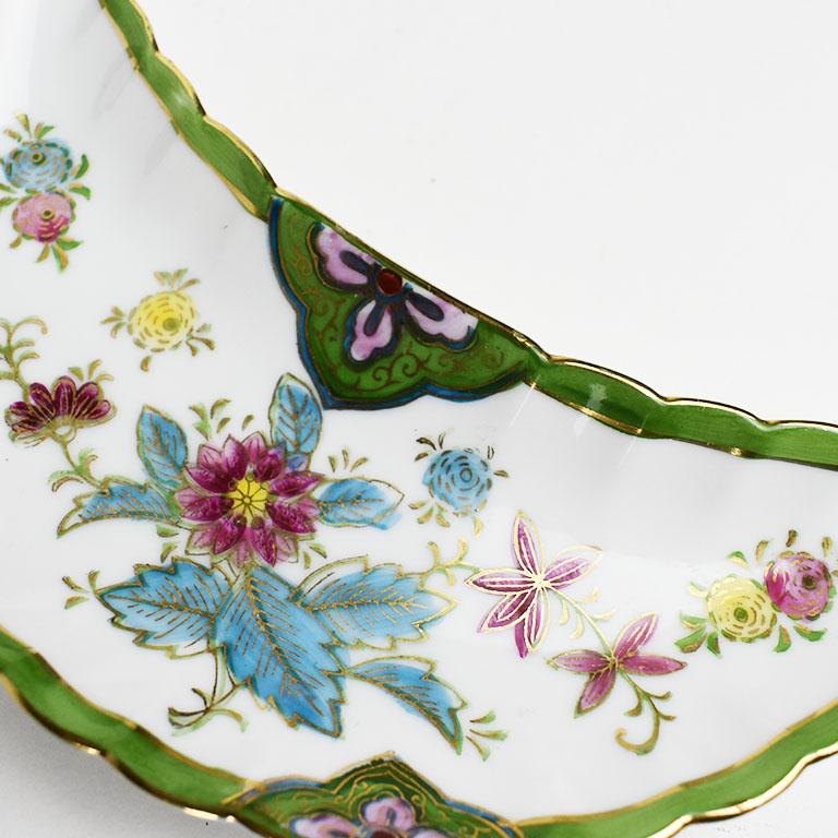 A ceramic Crecent shaped dish with hand painted green, red and gold decorations. A lovely piece with felt pads at the bottom for protection of surfaces. 

Dimensions:
6.75