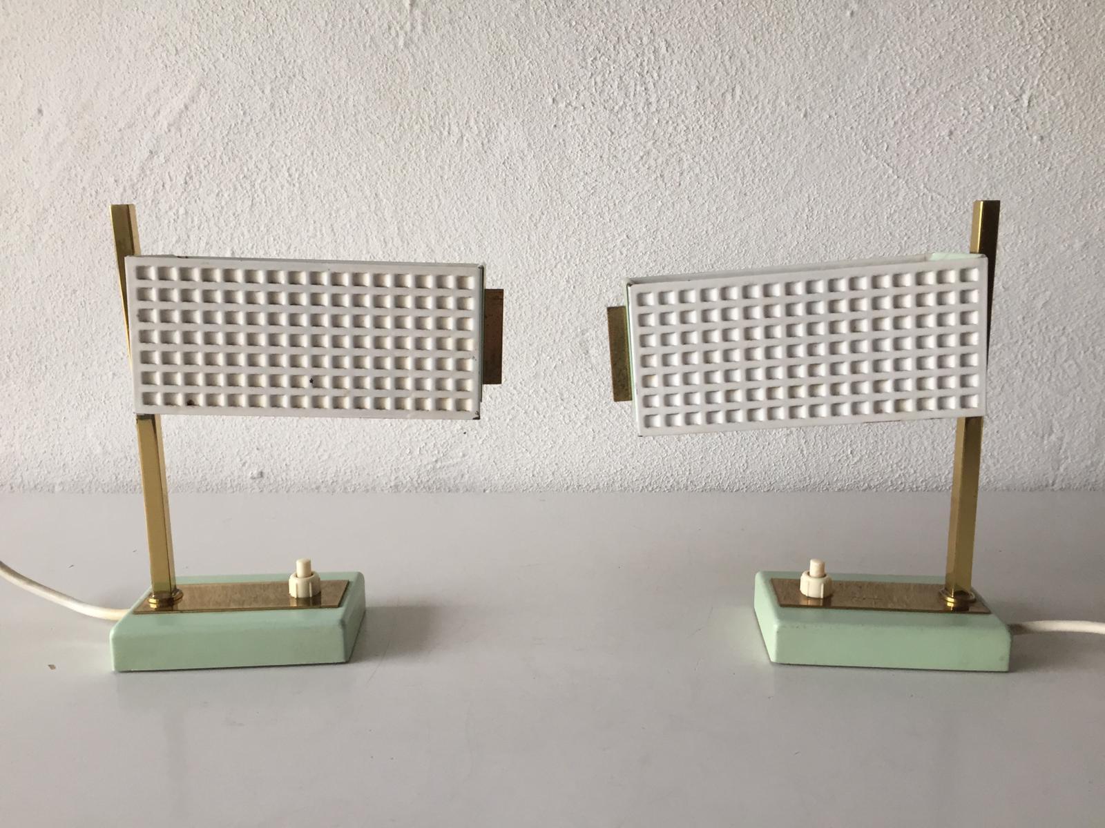 Green and white metal pair of table lamps style of Mathieu Matégot, 1950s

Minimal and very high quality design
Fully functional.

These lamps made of perforated metal and brass.

Original cable and plug. These lamps are suitable for EU plug socket.