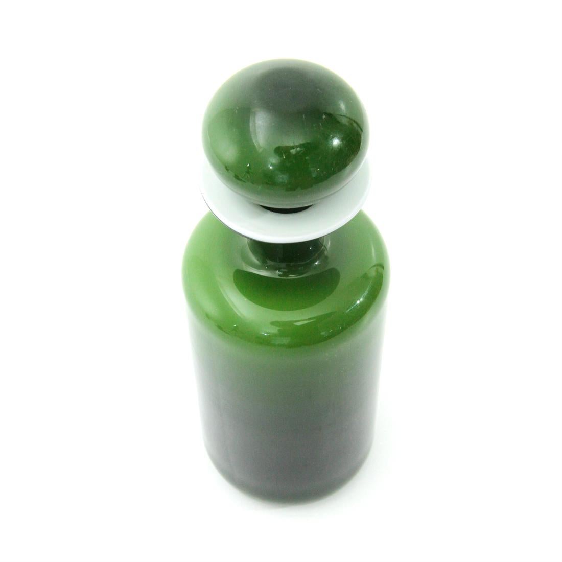 Vase produced by Holmegaard in the 1960s based on a design by Otto Brauer.
Green glass with white glass interior.
Green glass stopper.
Good general conditions, some signs due to normal use over time.

Dimensions: Diameter 8.5 cm, height 25 cm.