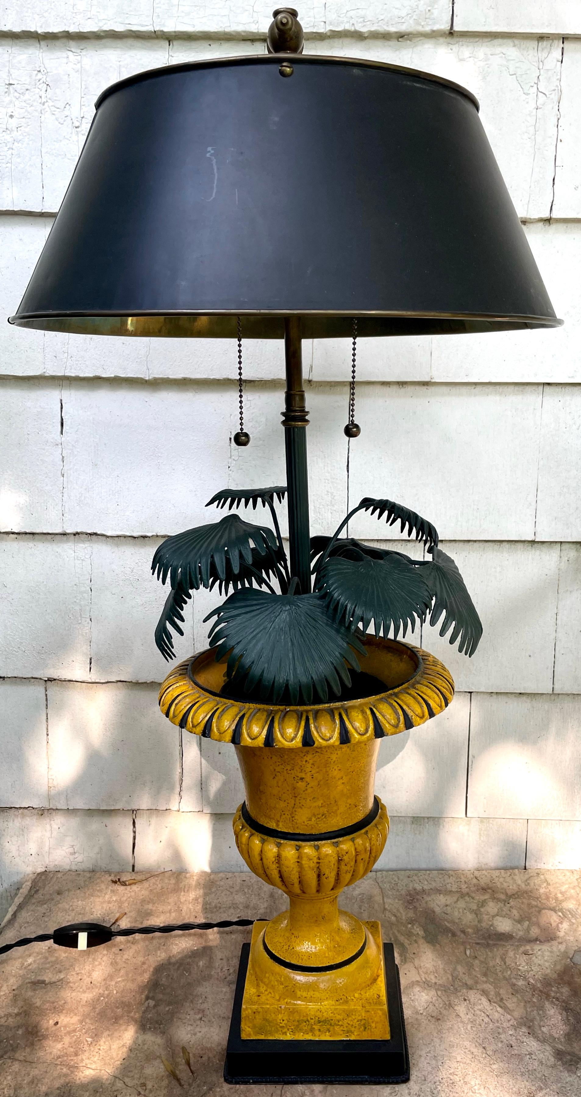Green and yellow potted palm urn lamp. French green painted tole palm tree lamp newly rewired in yellow and black painted metal urn. France 1910’s
Dimensions: Urn 9.5” diameter x  13” high to top of urn; 29” high to finial; base 5.5