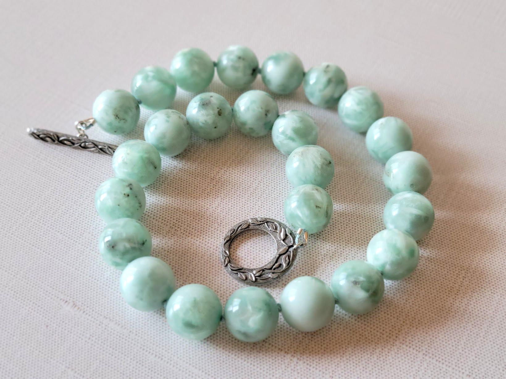 This stunning necklace measures 17.5 inches (45 cm) in length and features smooth 16mm round beads—a true cute piece.

The soft pastel green hues of Green Angelite are beautifully complemented by a silky luster and delicate snow-white flecks. Each