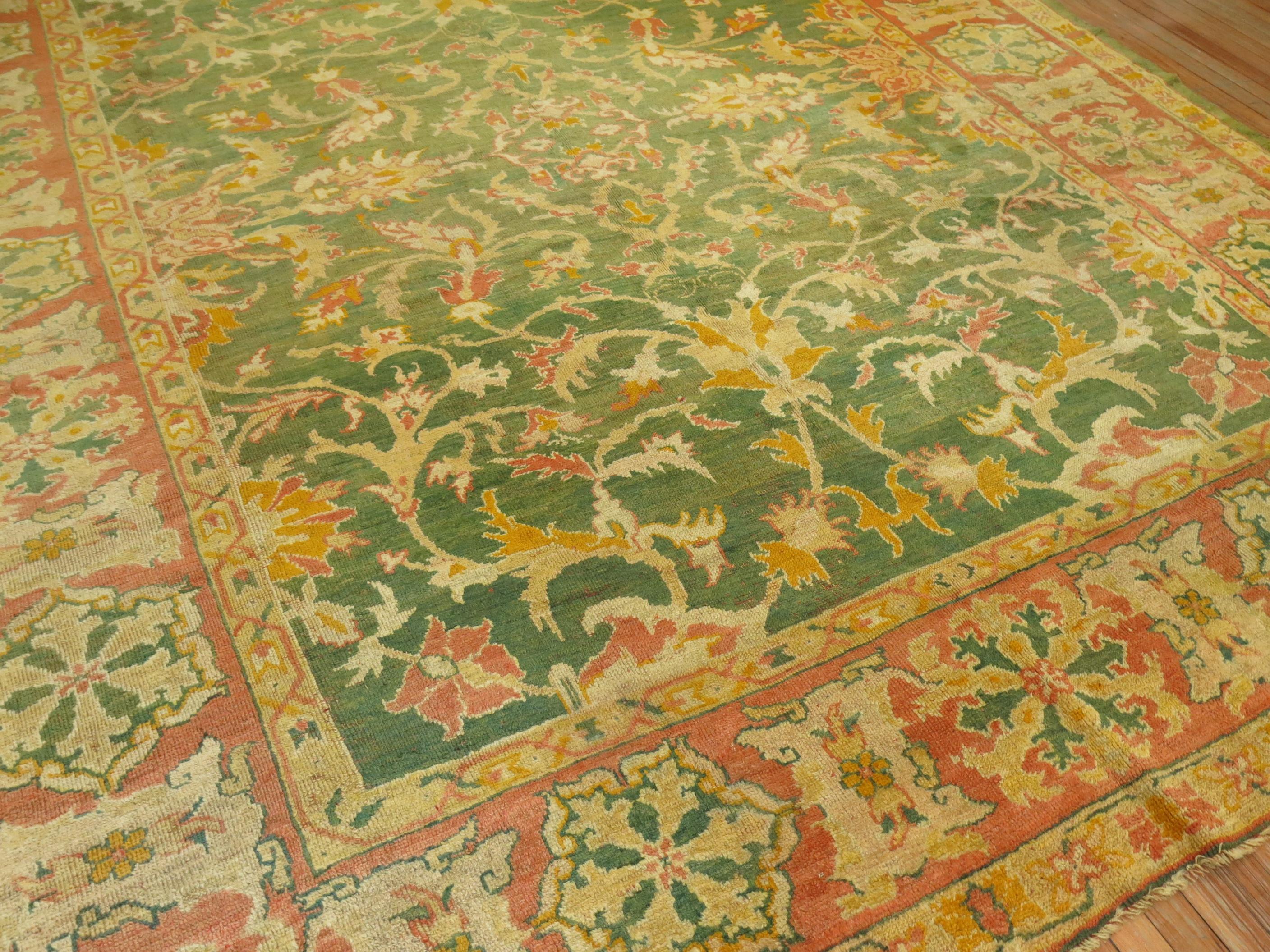 Phenomenal room size antique Oushak rug from the 19th century with a bright green background.