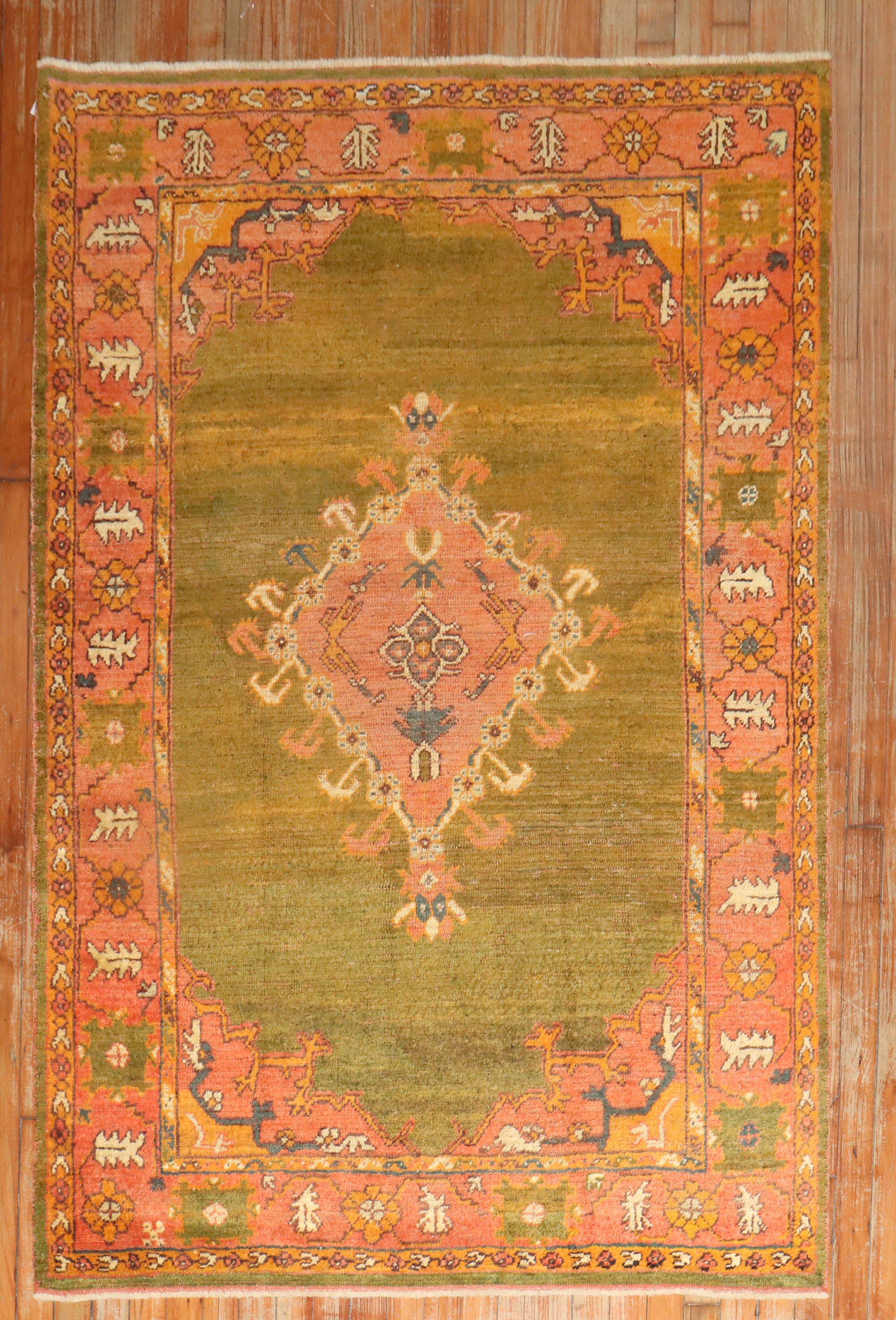 An early 20th century Antique Turkish Oushak rug highlighted by a rare green color ground.

Measures: 4' x 6'6''.