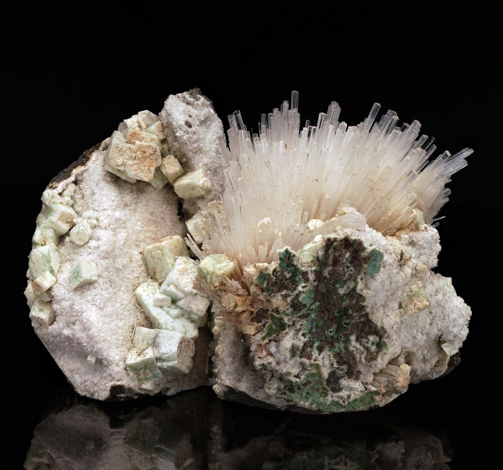 This unique sculptural specimen features a fiber optic explosion of scolecite contained in a rocky matrix on one side and cubic green apophyllite cascading down the face of the other side of the divided cluster. A truly one of a kind, visually