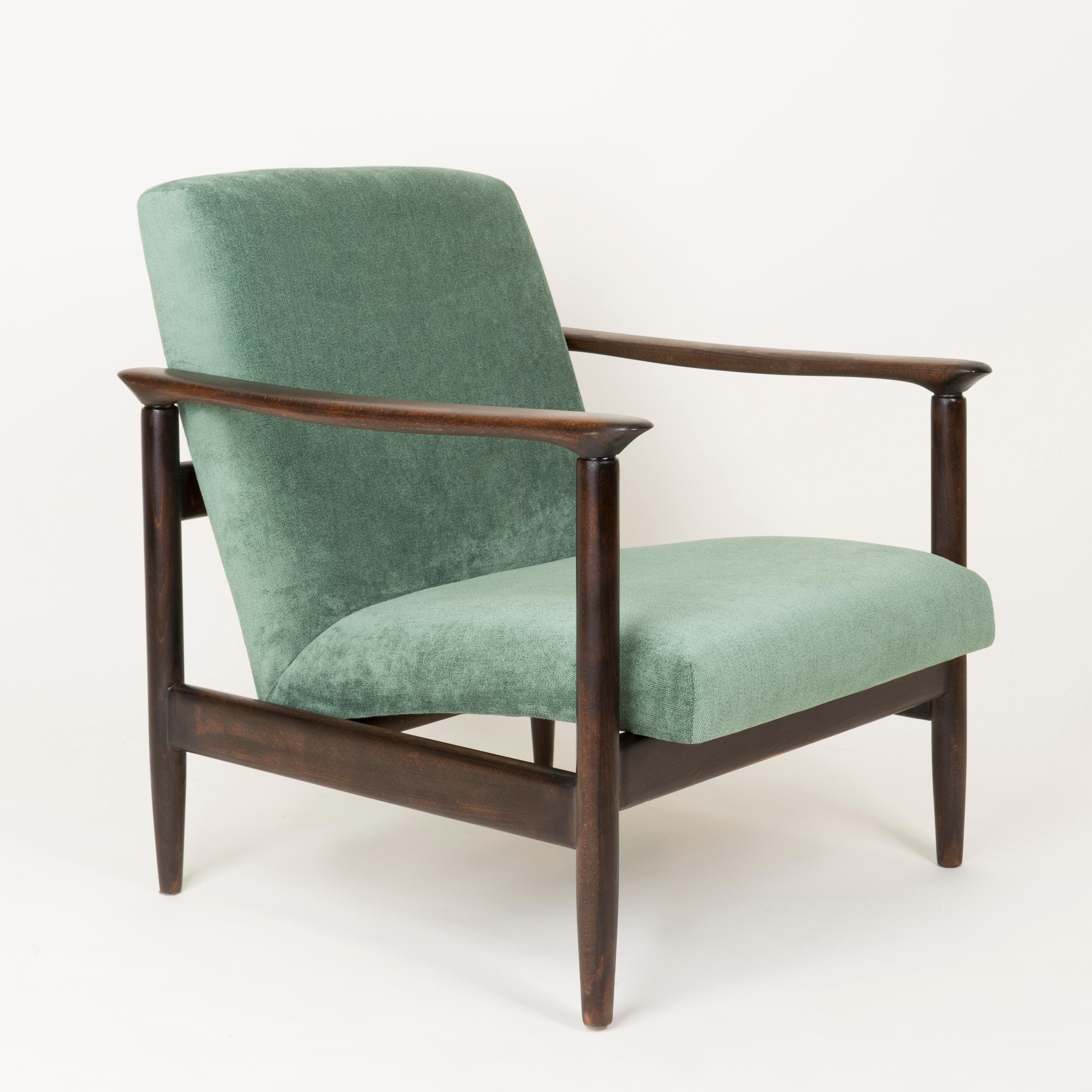 Set of armchair and foot stool GFM-142 type, designed by Edmund Homa. The armchair was made in the 1960s in the Gosciecinska Furniture Factory. They are made from solid beechwood. The GFM-142 armchair is regarded one of the best polish armchair