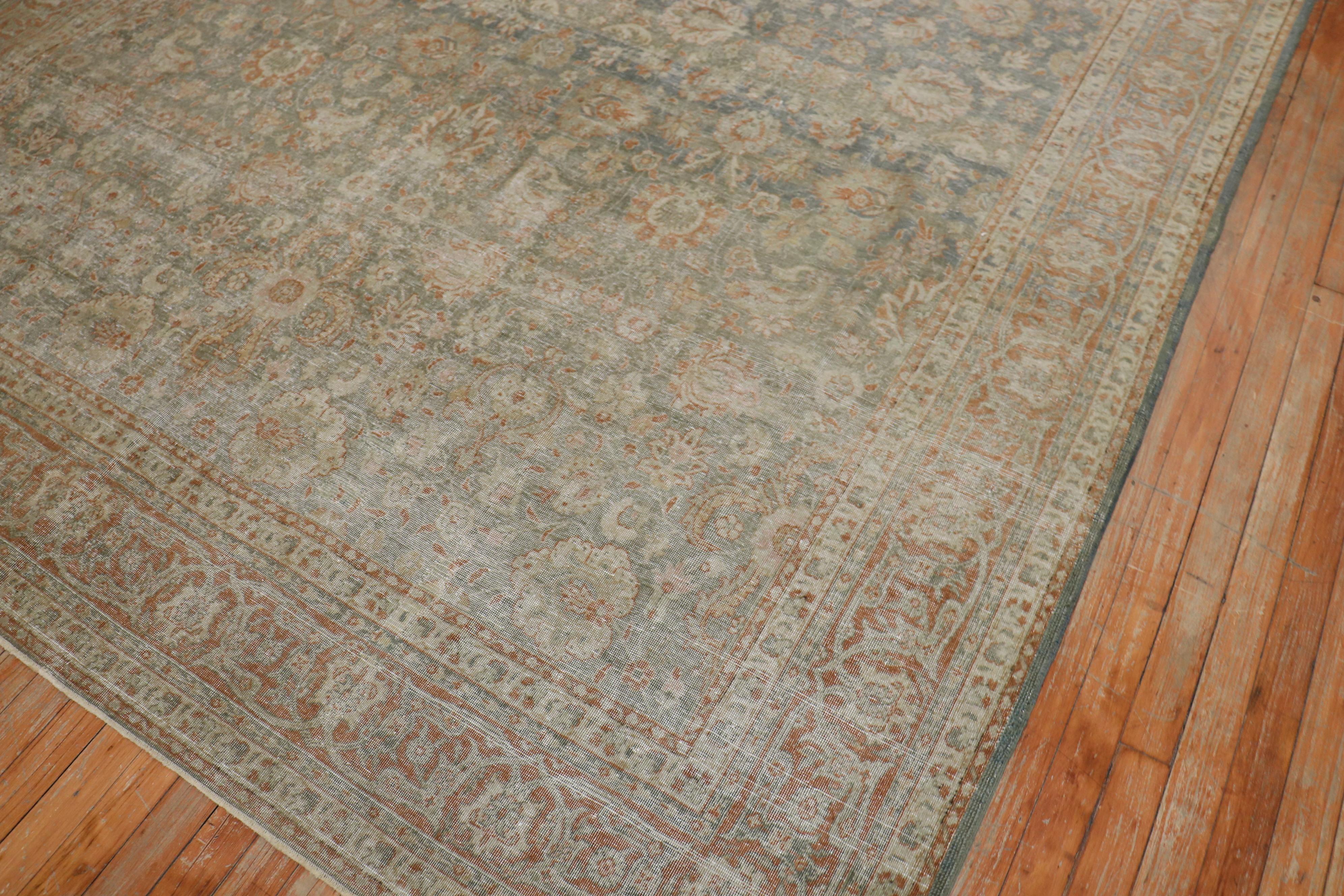 An early 20th century Persian Tabriz distressed rug in green and brown tones

Measures: 7'5'' x 9'7''

An antique Tabriz can be made of cotton or silk and woven as a pile carpet or flat-weave. A refined palette reliant on copper tones,