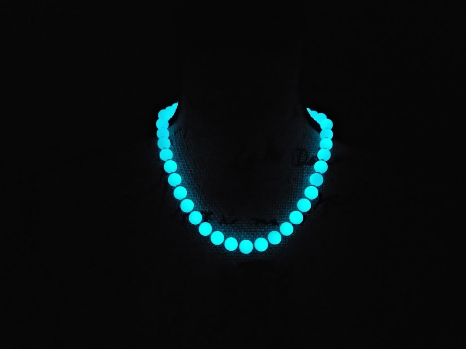 The length of the necklace is 17.5 inches (44.5 cm). The size of the smooth round beads is 10 mm. Beads are a light green color.
This is a naturally occurring glow-in-the-dark gemstone. Aragonite possesses natural phosphorescence, causing it to emit