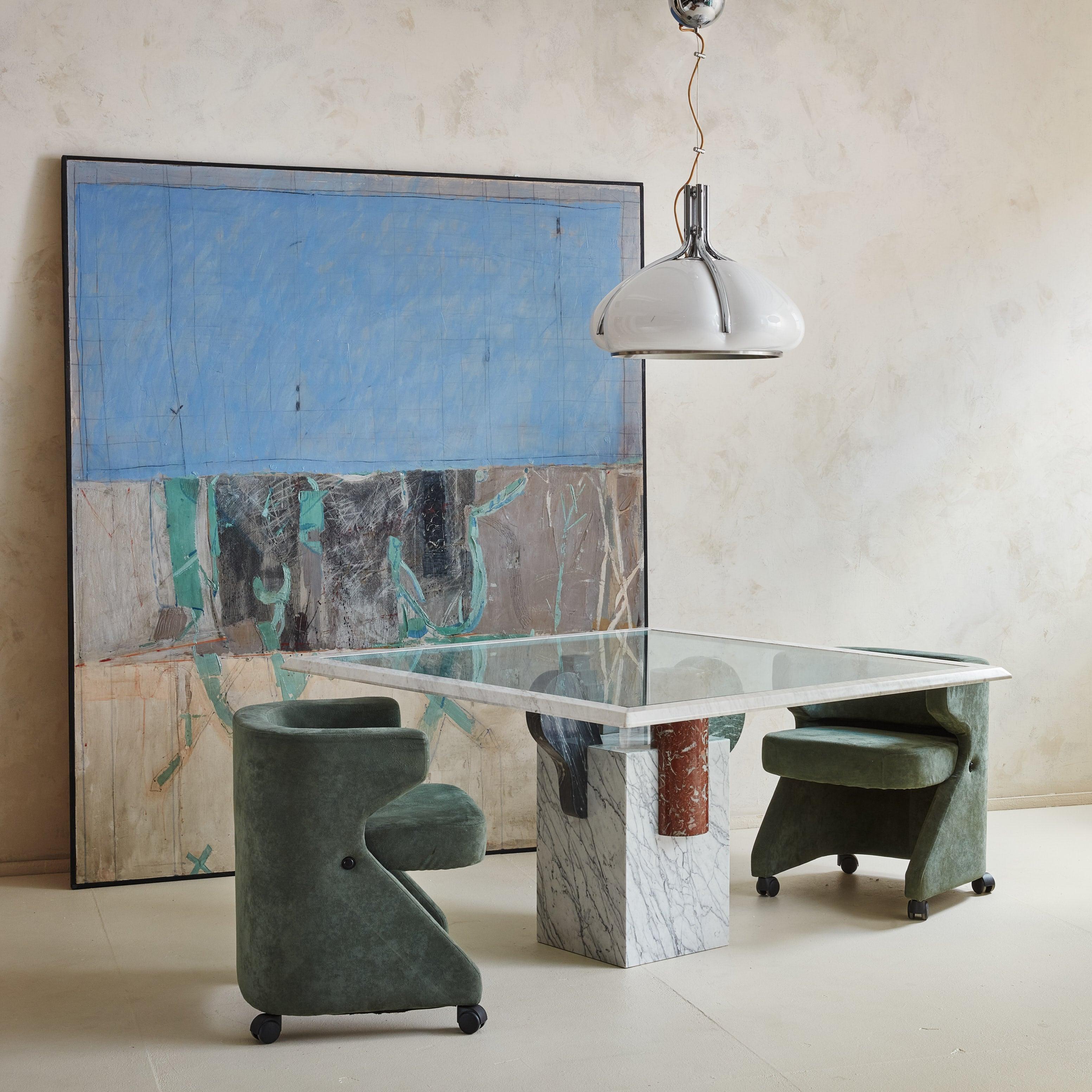 A 1970s armchair on casters attributed to Gianni Moscatelli for Formanova. This sculptural chair features a striking profile with straight arms and an angled base supported by casters, allowing for easy mobility. The chair includes original green