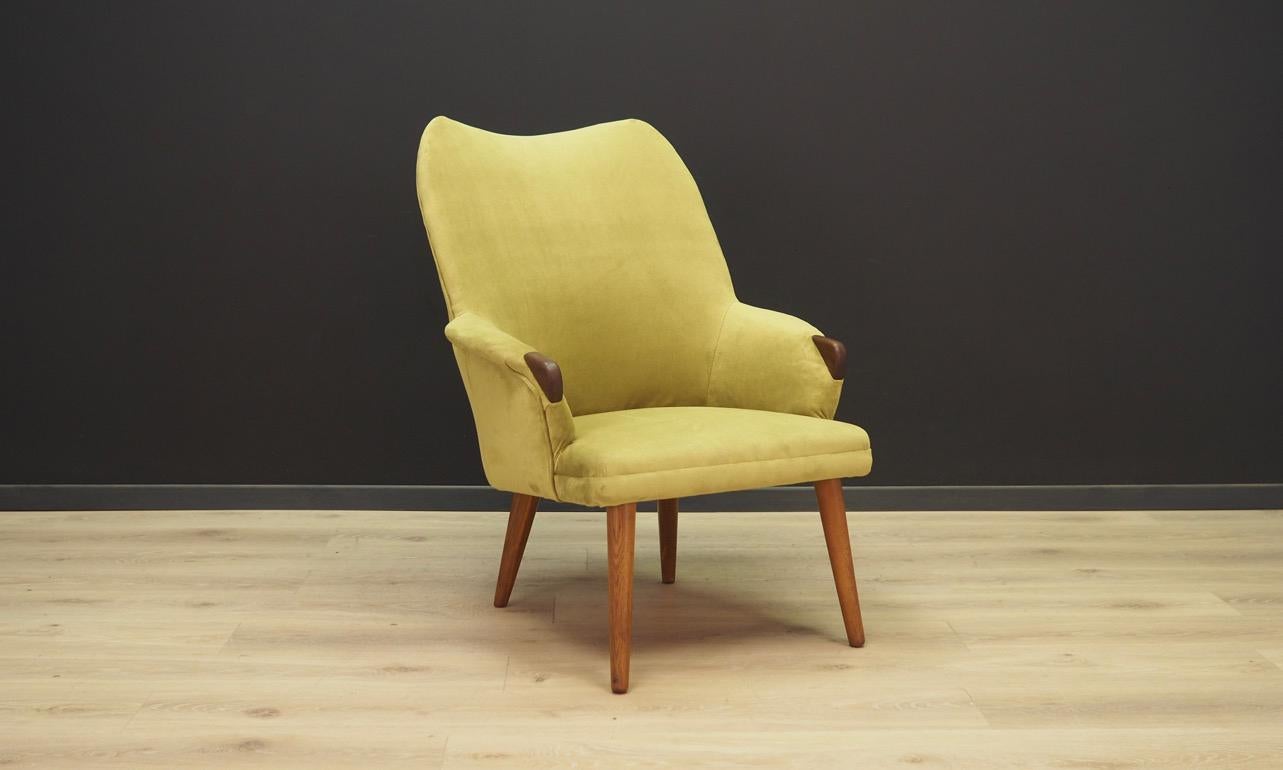 Fantastic armchair from the 1960s-1970s, Danish design. Original upholstery made of easy to clean, dirt resistant fabric in green. Armrests finished with teak wood. Maintained in good condition (minor bruises and scratches) - directly for