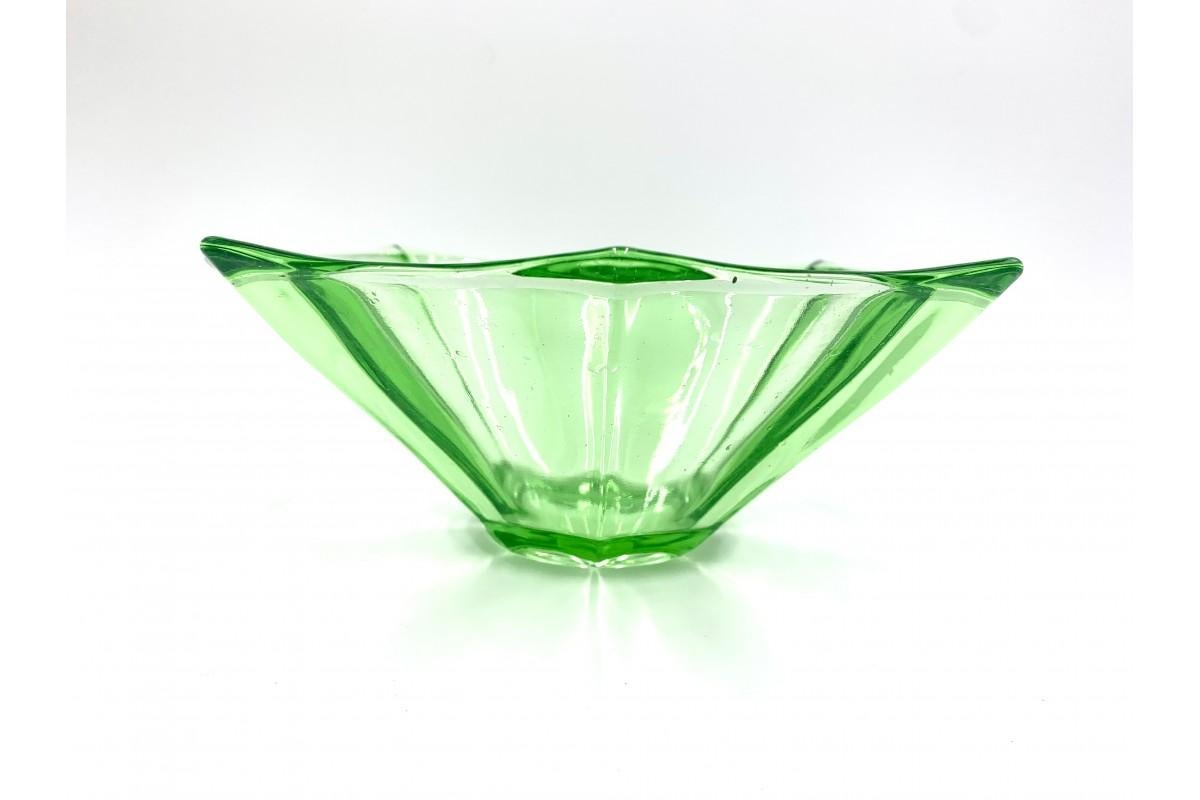 A green bowl made of pressed glass, manufactured by HSG 