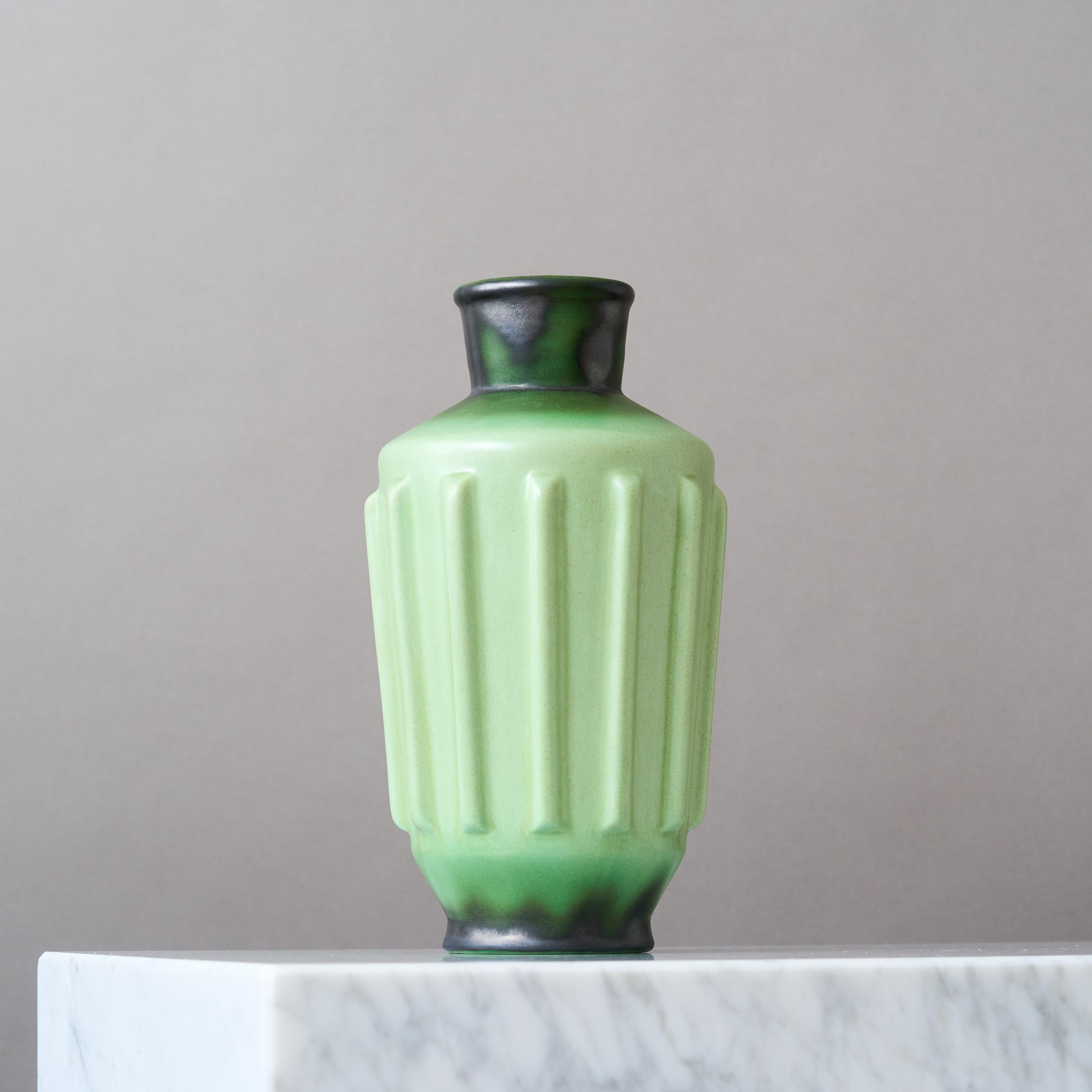 A beautiful Art Deco vase with amazing green glaze. 
Designed by Ewald Dahlskog for Bo Fajans (Bobergs Fajansfabrik), Sweden, 1930s.

Great condition, no chips, cracks or crazing.
Impressed signature 'ED' and makers marks on base of vase. 

Ewald