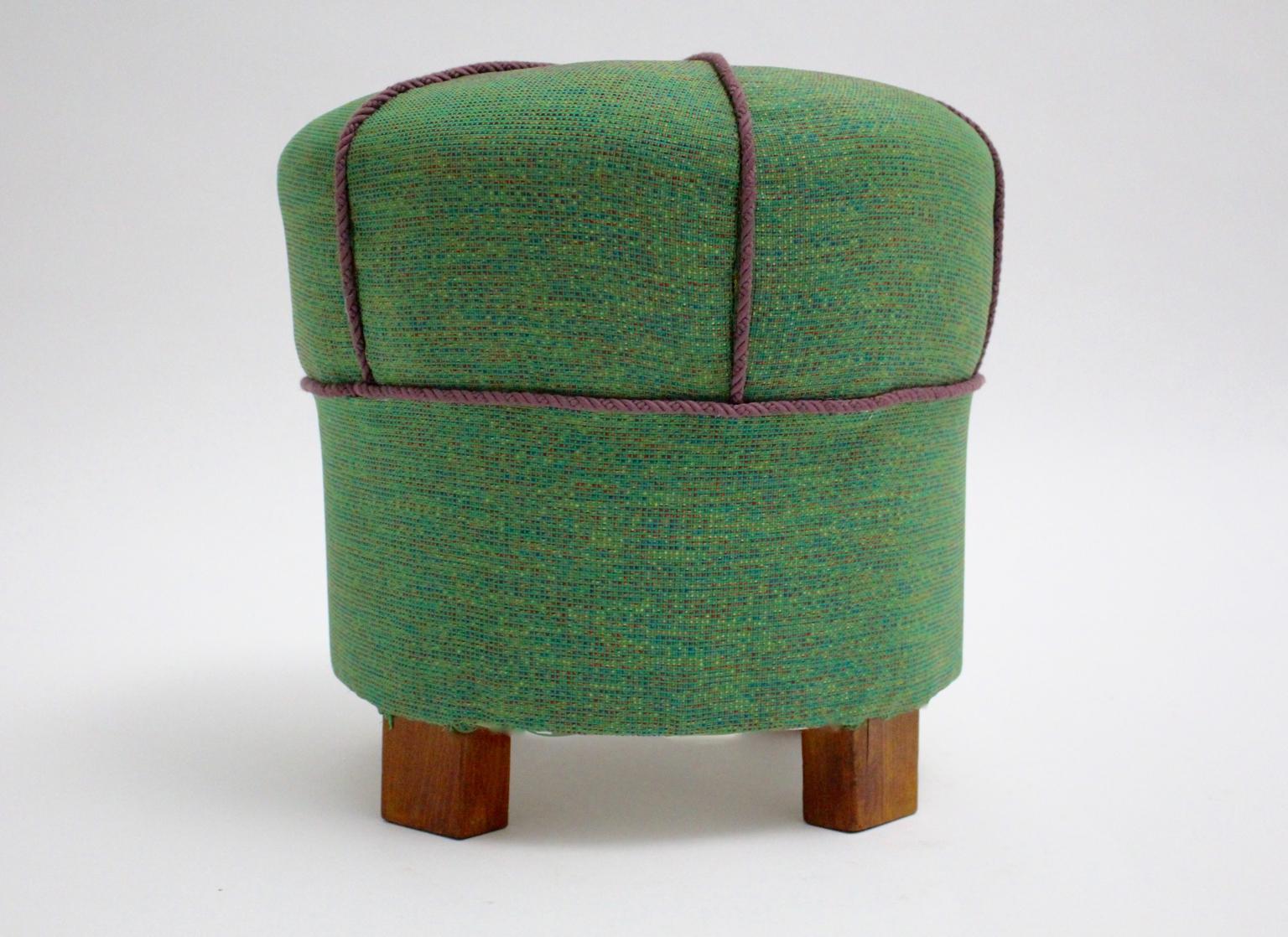 Charming Art Deco pouf, stool or tabouret. The tabouret is newly covered with green textile fabric and decorated with violet cords.
The stool features walnut feet.
all measures are approximate