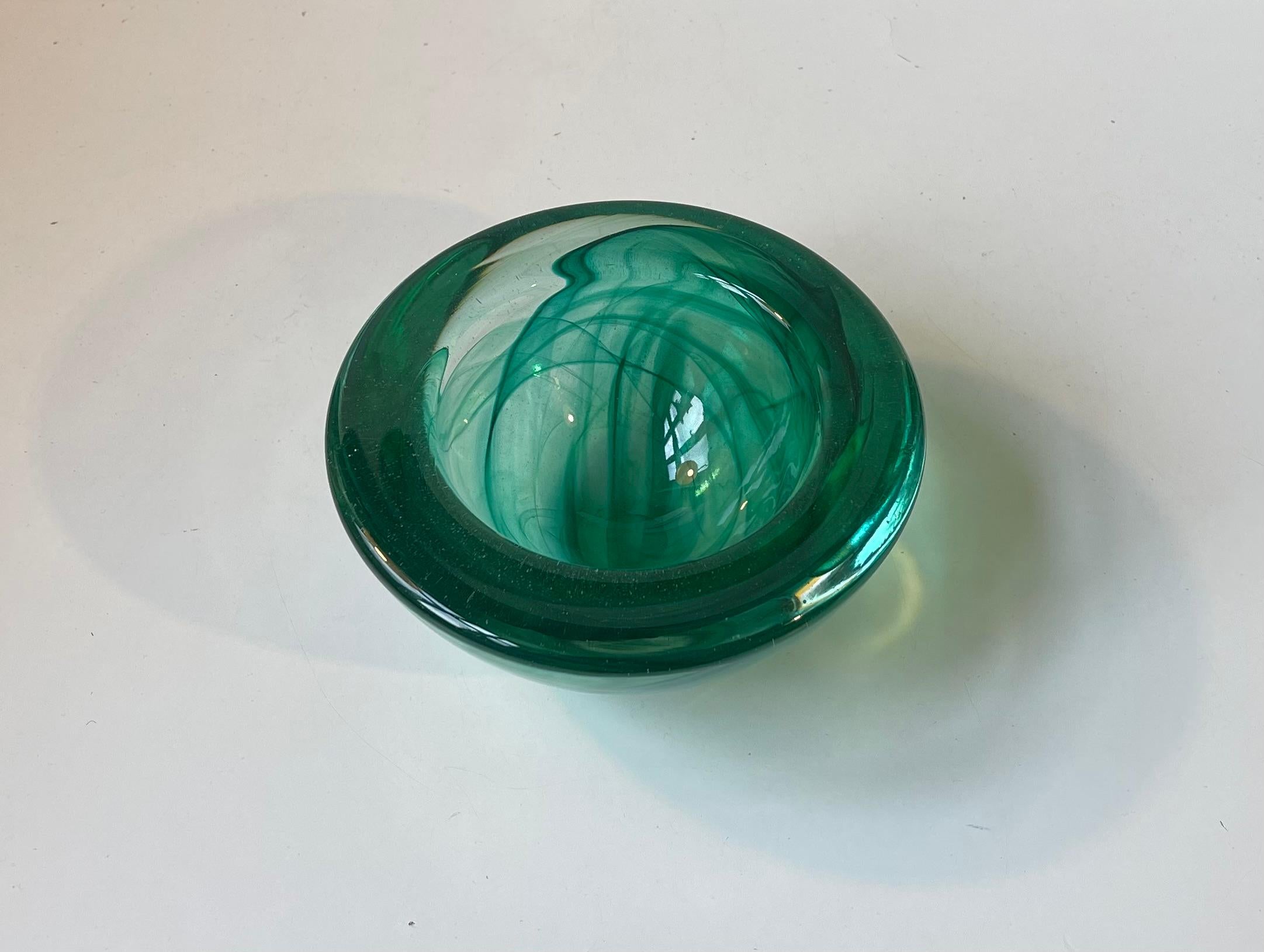 Thick and heavy conical art glass bowl from Kosta Boda in Sweden. It was designed by Anna Ehrner in the mid 1980s. The bowl is called Atoll and it features swirl-work to the inside of the bowl. Original sticker from Kosta Boda still present to the