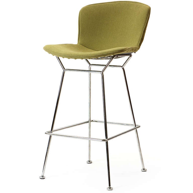 A spare and sculptural stool crafted from shaped steel rods retaining the original woven green wool upholstery. Measures: 40.5