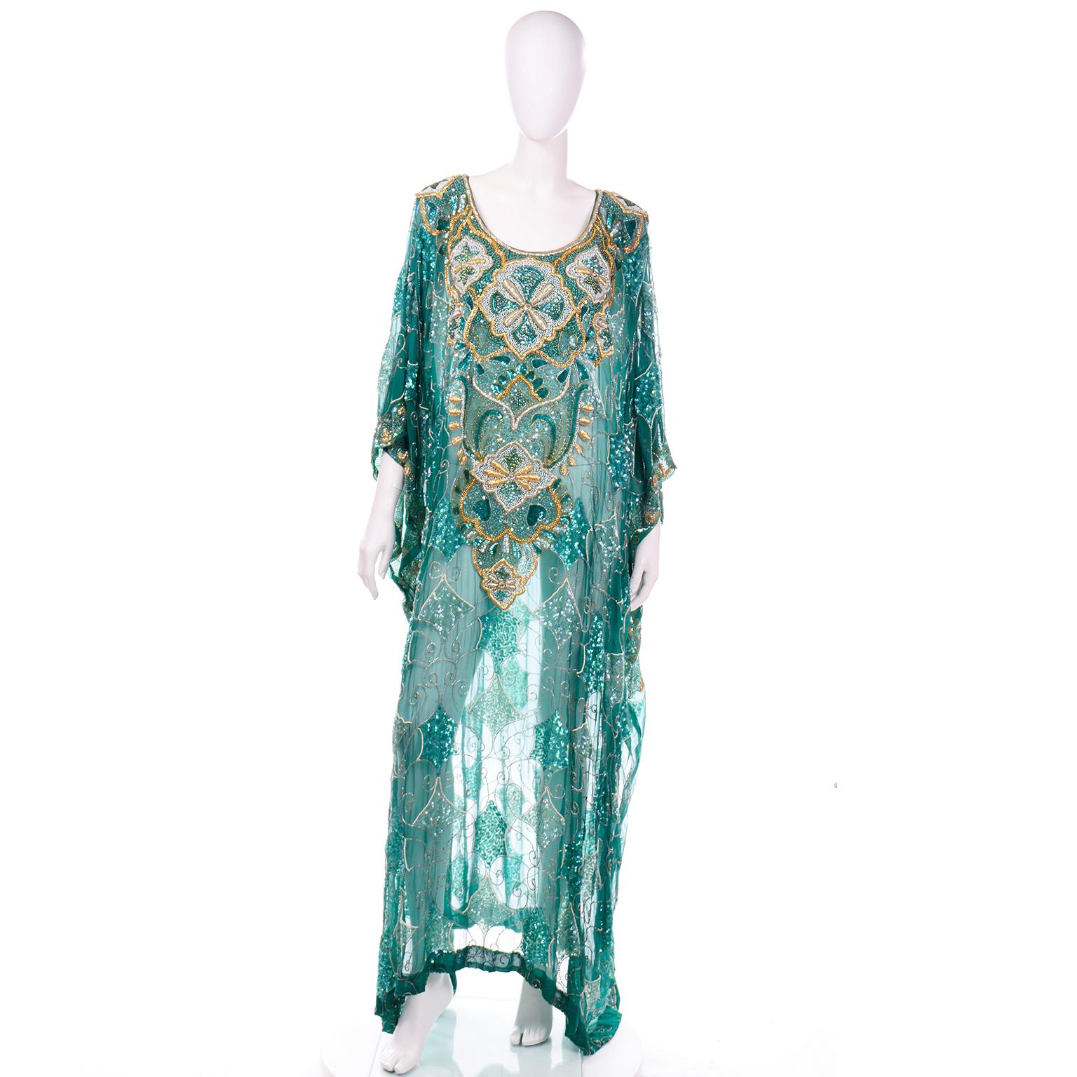 This is a truly stunning brilliant green fully beaded and sequin caftan style floor length evening dress. Dresses like these are so exquisite and this one came from a prominent estate we purchased that included fabulous vintage beaded evening gowns